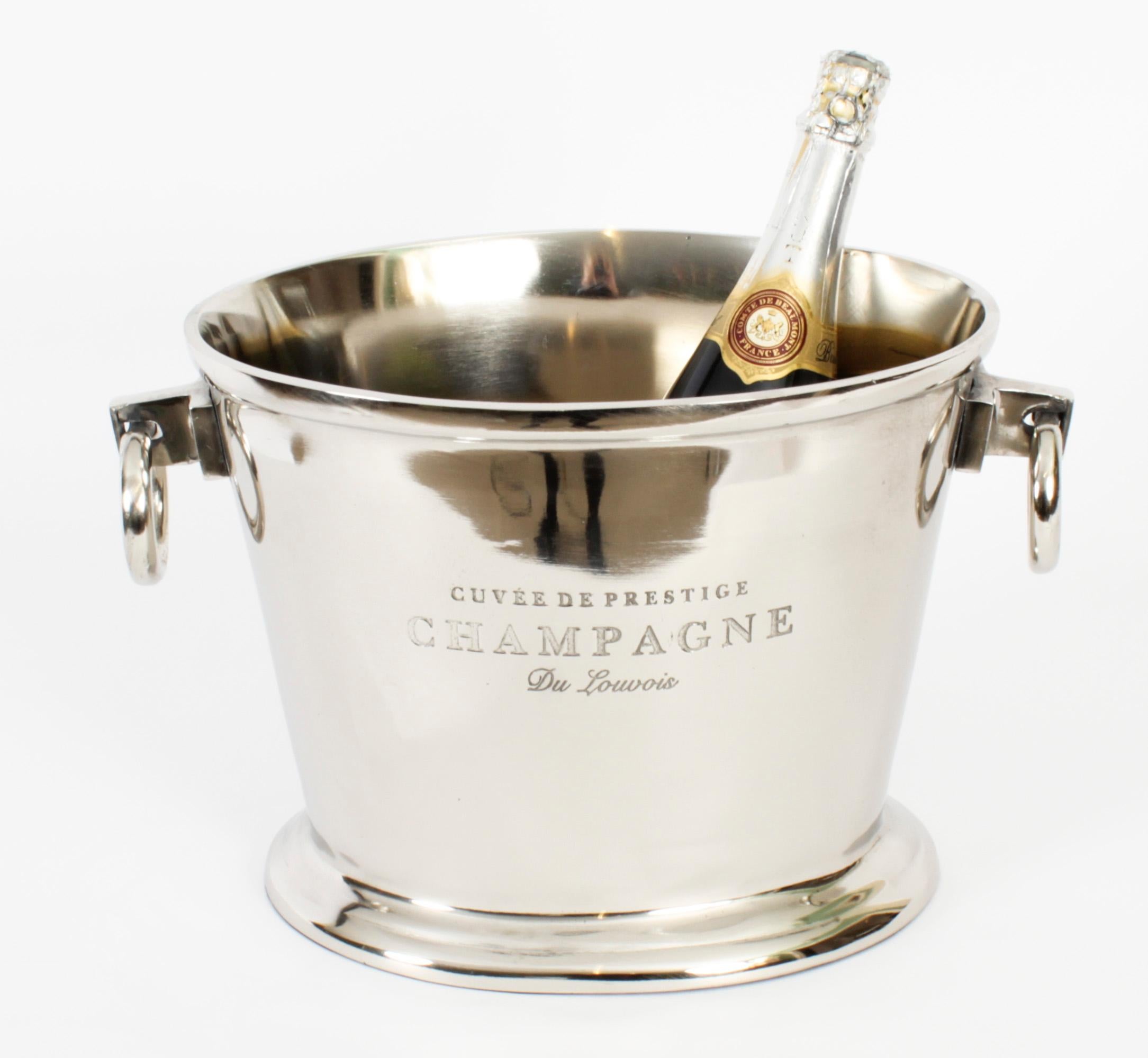 This is a gorgeous vintage nickel plated champagne cooler dating from the late 20th Century. 

It is engraved Cuvee de Prestige Champagne boldly on to the side.

The cooler has twin carrying handles and there is no mistaking the unique quality of