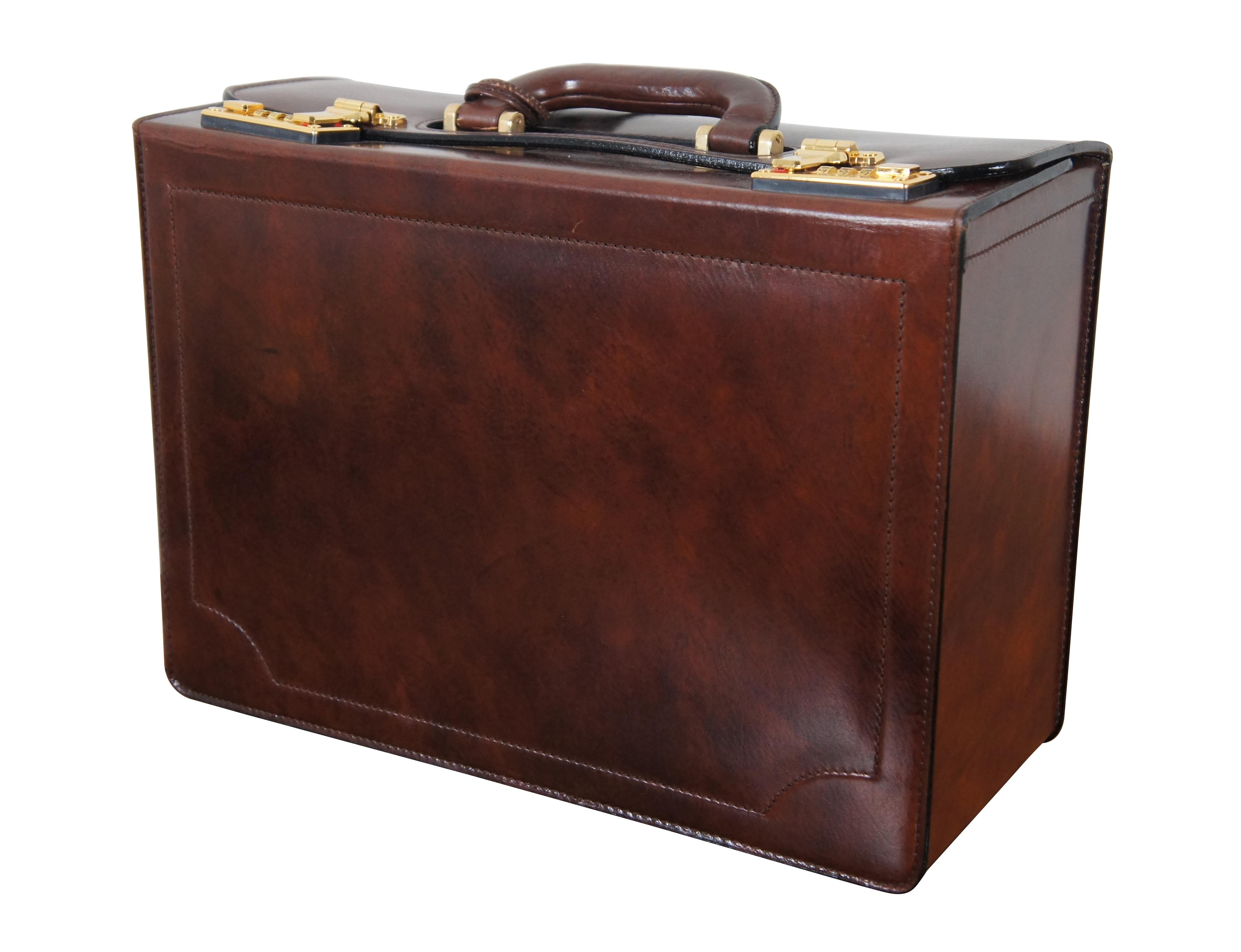 Vintage mottled brown leather brief case / document case featuring brass feet, single handle, overlapping flap top, and double latches with Presto Top Change combination locks (currently set to default 000). Interior features three divided sections