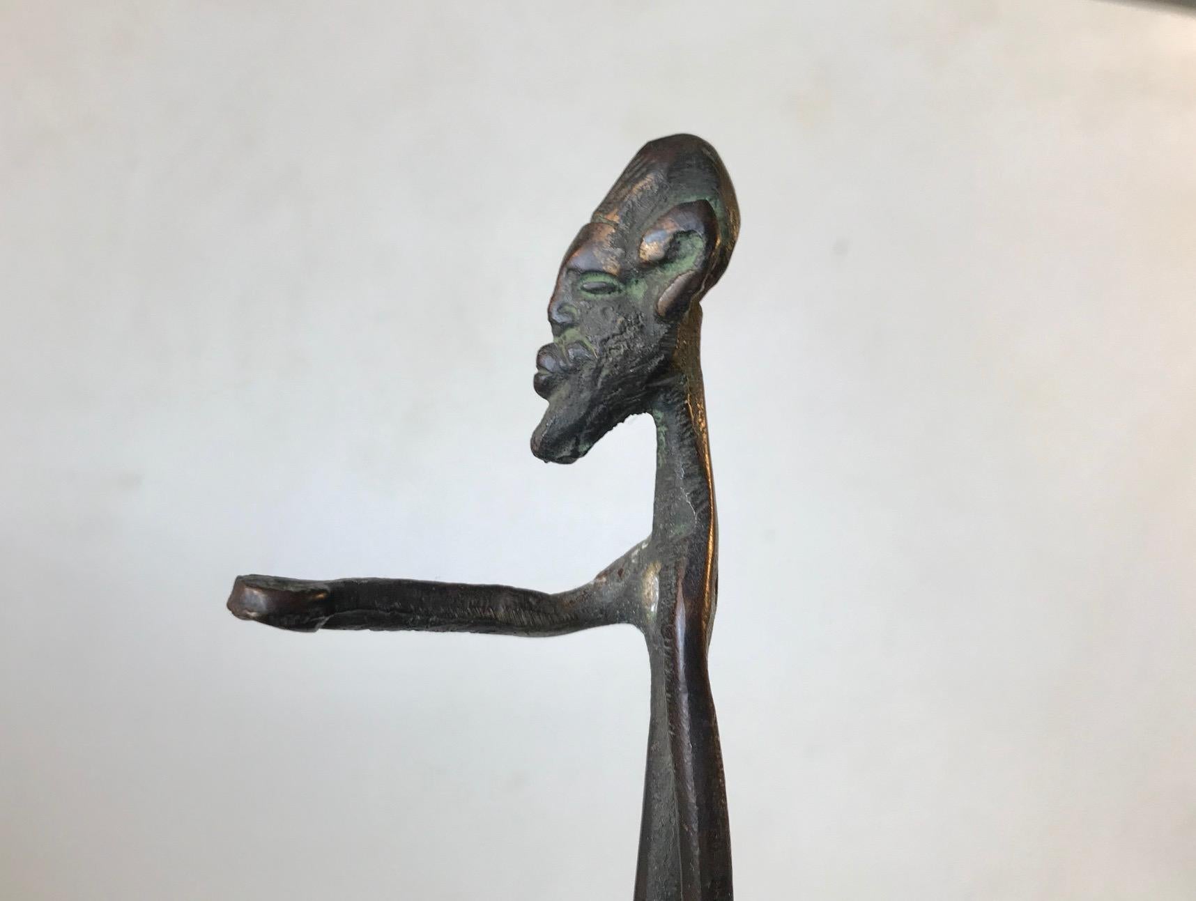 Unusual vintage African bronze sculpture. Primitive/naive depiction of old naked tribesman. It was brought from Africa in the 1970s. This piece is not signed/marked.