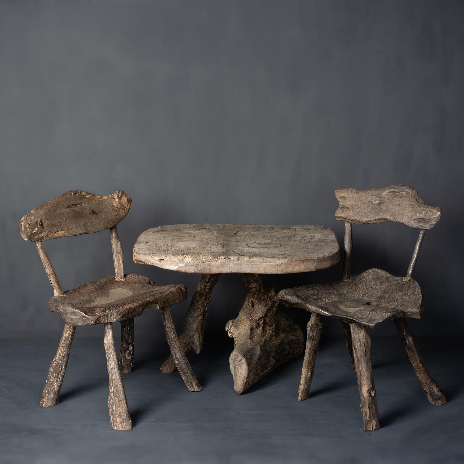 VINTAGE RUSTIC TREE TRUNK CHAIRS AND TABLE
Made from joined pieces of Bornean Ironwood (Eusideroxylon Zwageri) in their most naturalistic forms to create an almost grotto-style table and two-chair set.

Can be used inside or out.

They are in very