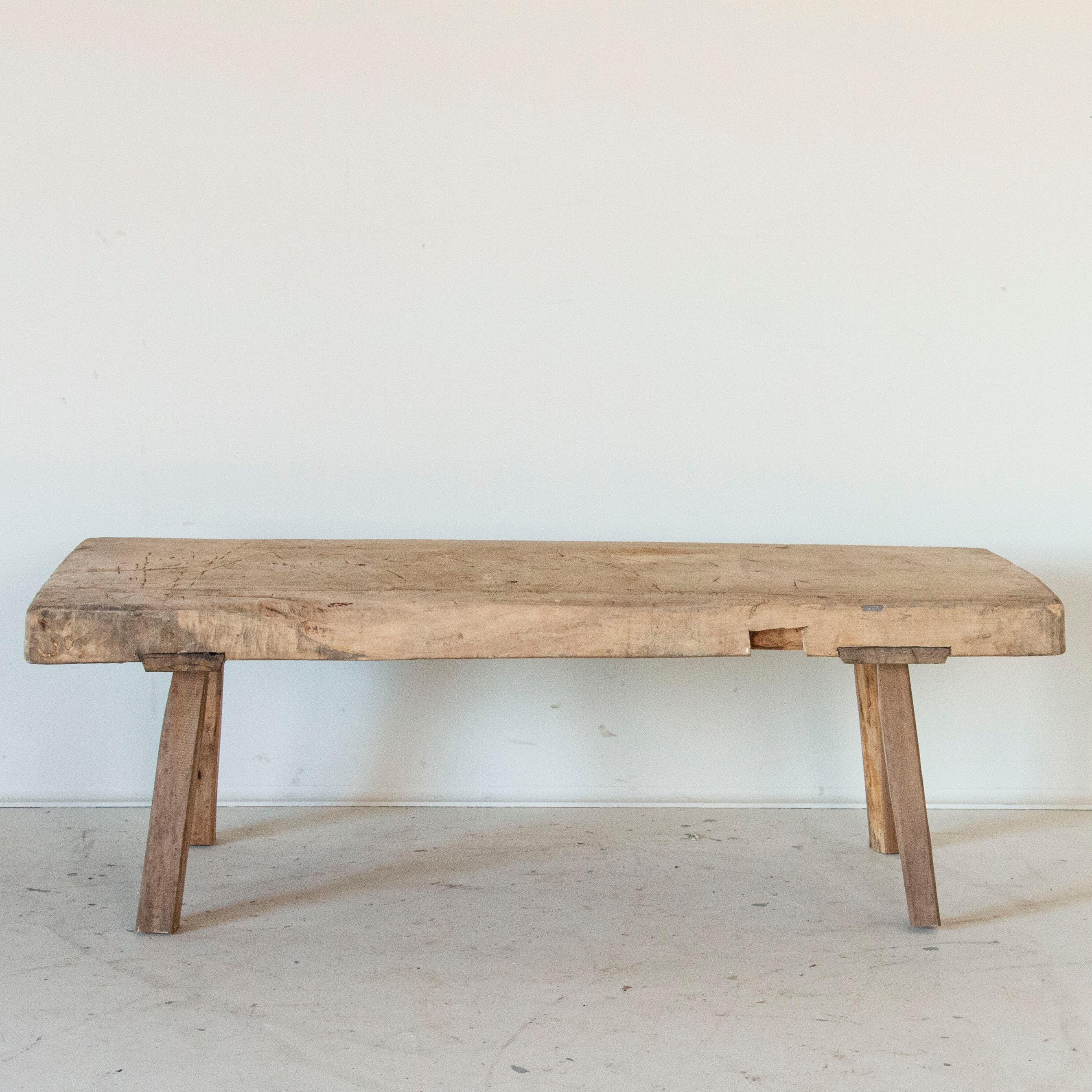 In person, you will be drawn to run your hand along the surface of this thick, slab wood topped coffee table. At almost 3
