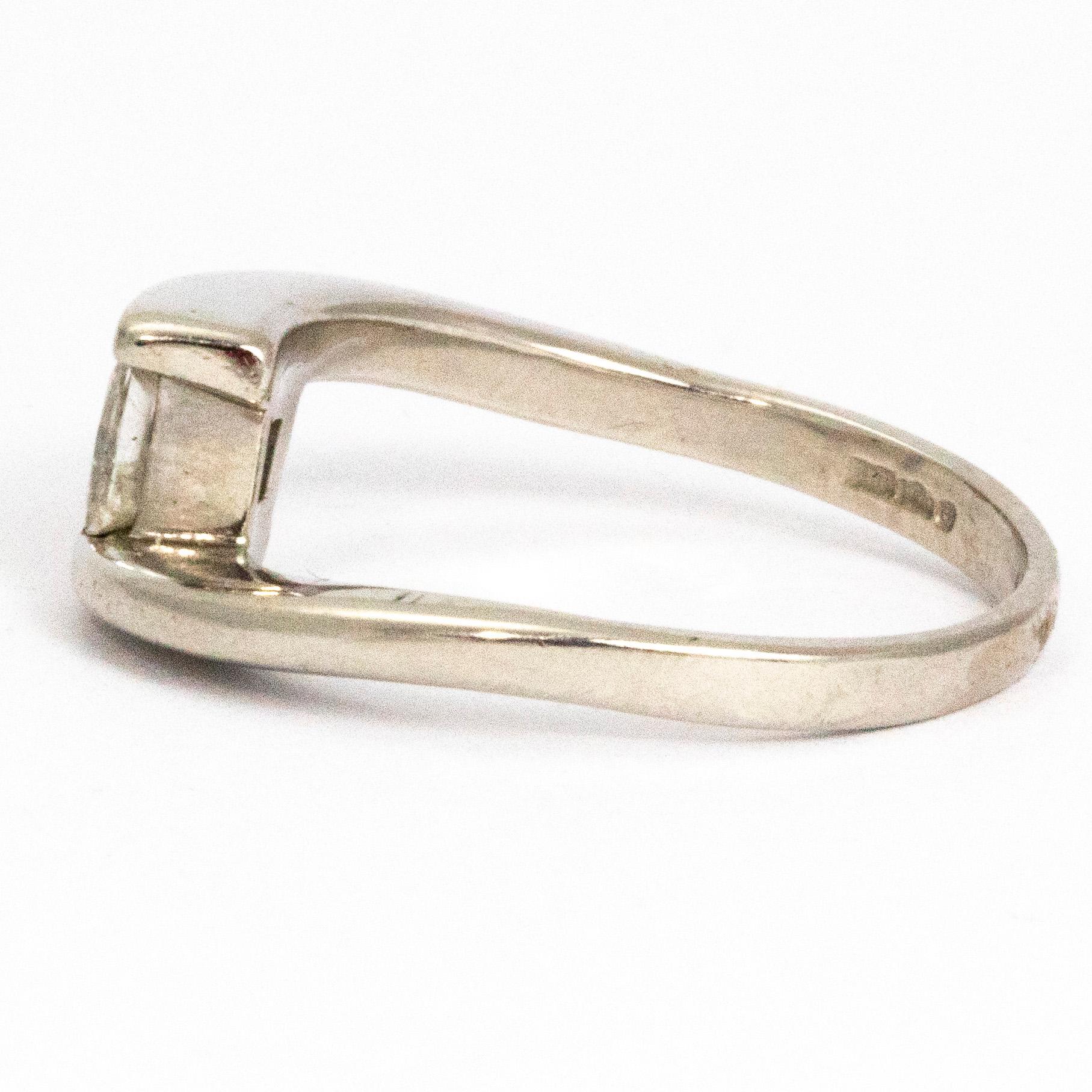 The princess cut diamond in this ring measures 40pts and is really beautiful. It is an H colour and has a gorgeous sparkle to it. The platinum band is wrap around which holds the diamond between the ends of the cross over band. 

Ring Size: N 1/2 or