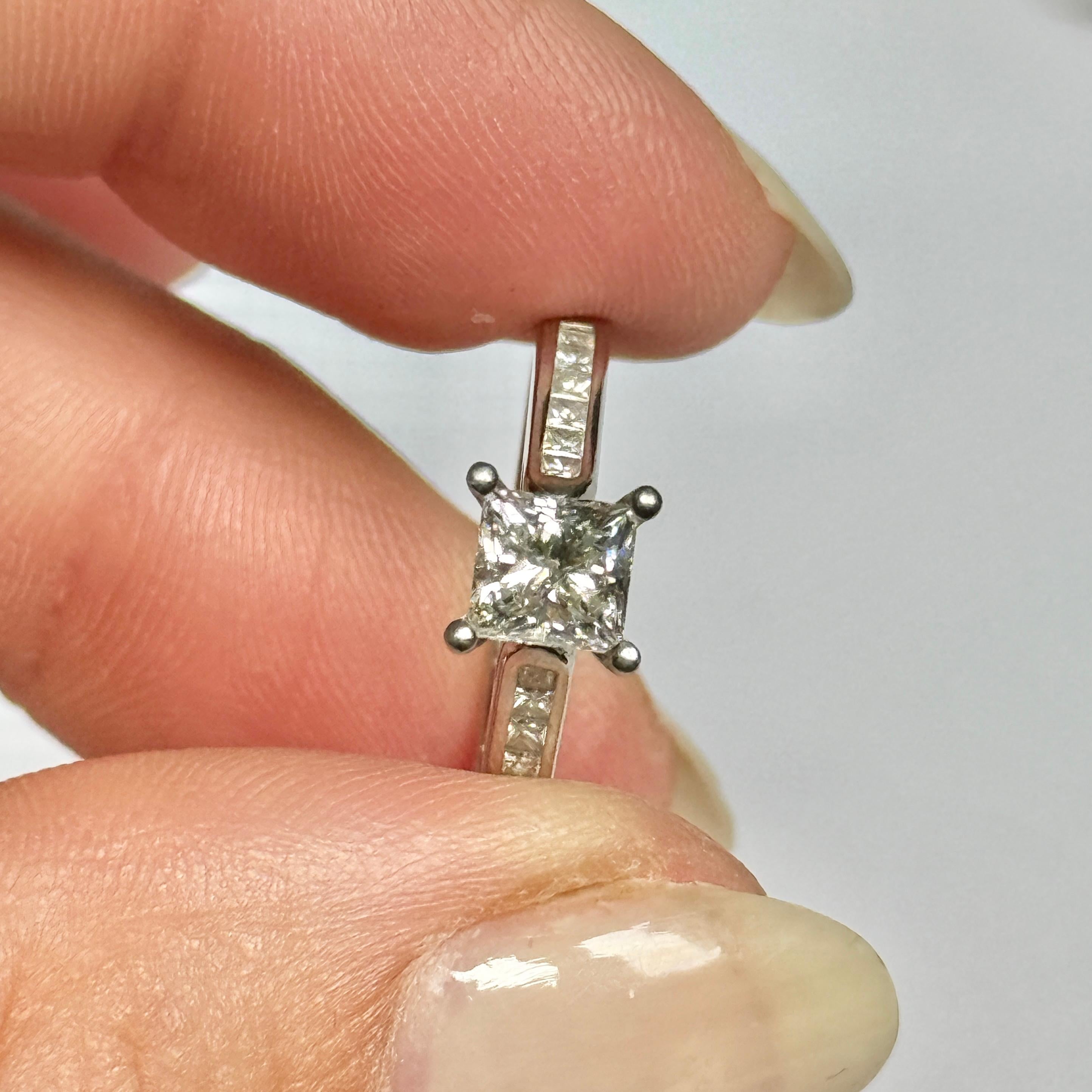 Dieser Ring eignet sich perfekt für die Verlobung oder einfach nur, um ein wenig Glanz in Ihre Alltagsgarderobe zu bringen. Der Diamant in der Mitte ist ein Prinzessschliff, der wunderbar funkelt, und die Schultern tragen jeweils eine Reihe von
