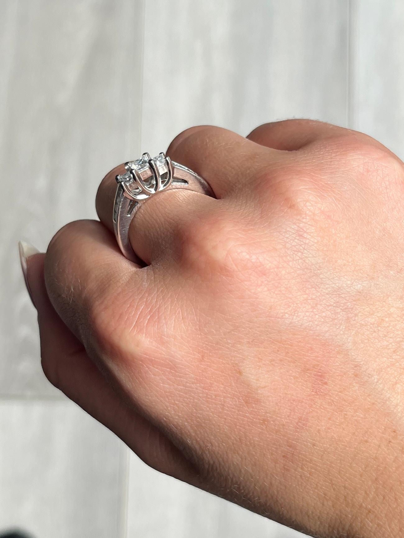 The sparkle of this ring is absolutely stunning! It holds three larger and more prominent princess diamonds which measure a total of 90pts and the shoulders also hold four smaller princes cut stones on each. The ring is modelled in platinum and the