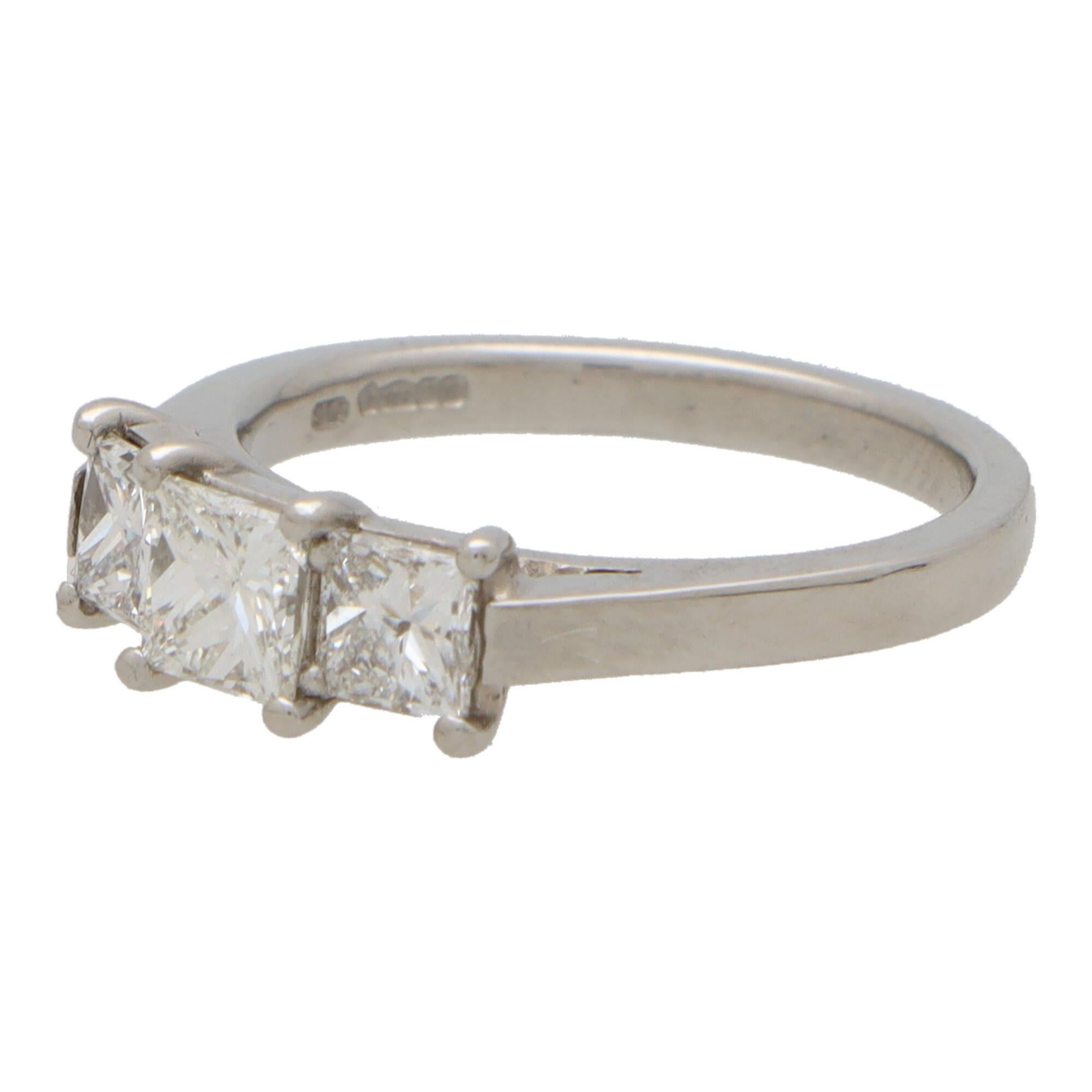 A beautifully crafted princess cut diamond three stone ring set in 18k white gold.

The ring is centrally set with a sparkly 0.41 carat princess cut diamond. This is then sided by two perfectly matched 0.27 carat princess cut diamonds. All the