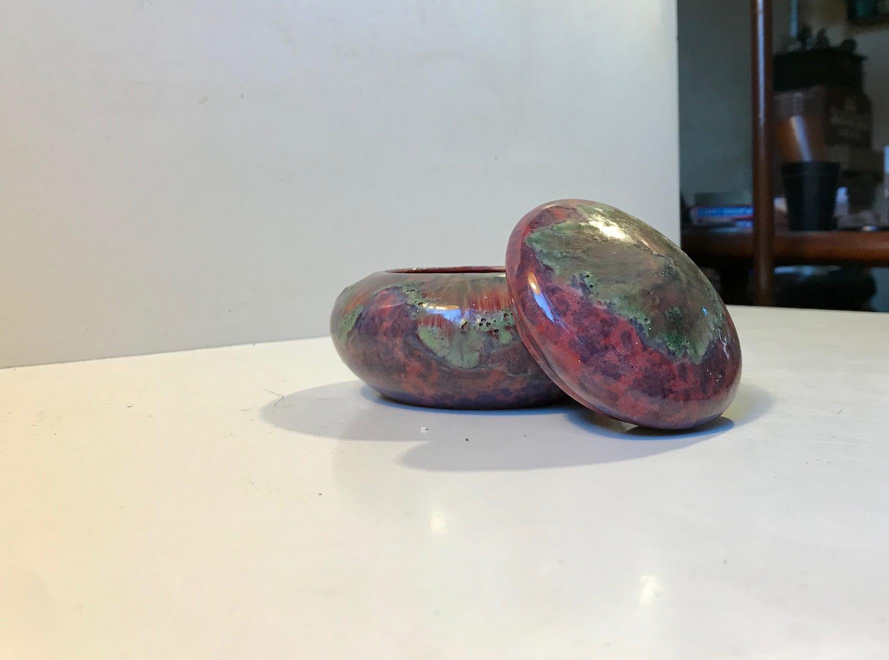 Ceramic trinket or lidded jar with psychedelic glaze. Created in the Voersaa Workshop in Denmark during the 1960s. Signed VO to the base.