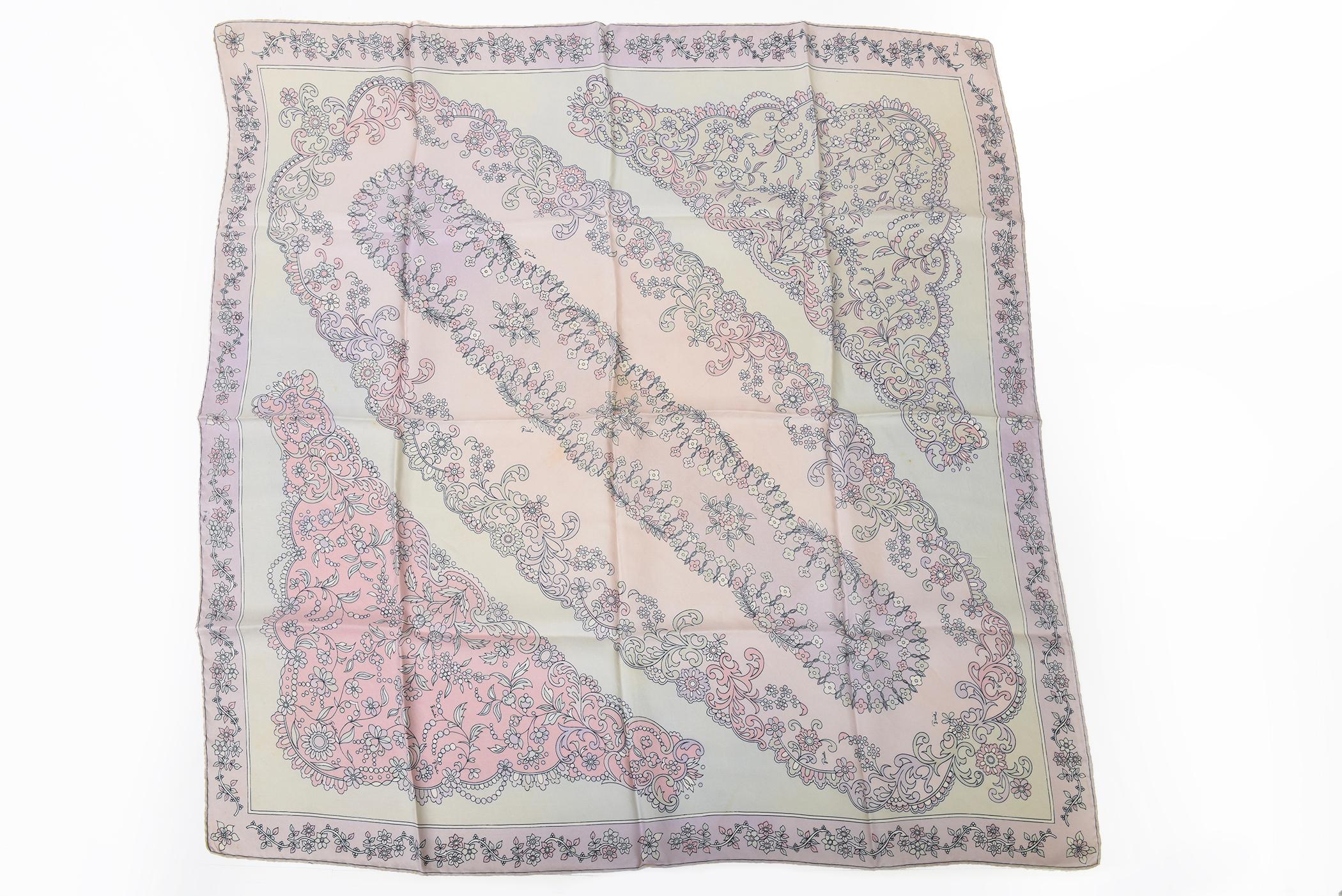 This vintage Emilio Pucci pastel silk scarf with rolled edges has its original box with a light pink interior. The box says Pucci on top.From the 70's. The colors of this lovely feminine scarf are light pink, light purple, black and light gray. The
