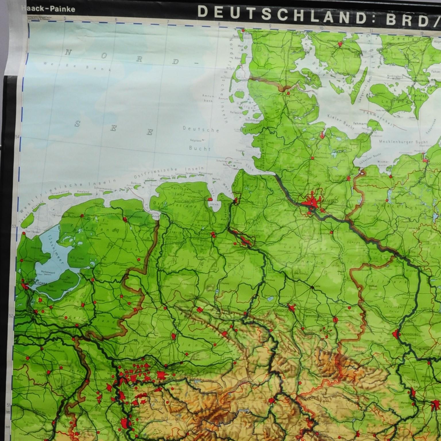A classical rollable vintage wall chart illustrating a map of Germany (Federal Republic of Germany and German Democratic Republic - while Germany was separated). Published by the Haack-Painke, Justus-Perthes-Darmstadt. Colorful print on paper