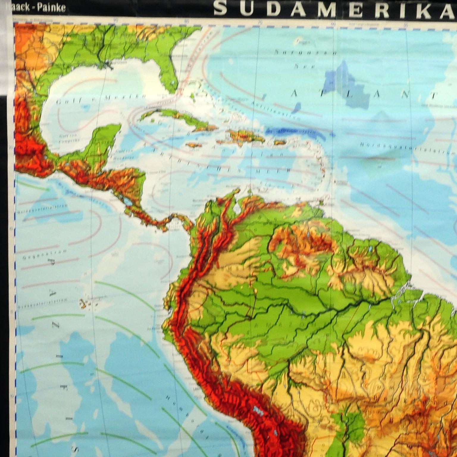 The wall map shows South America. It was published by Haack Paincke, Justus Perthes Darmstadt. Used as teaching material in German schools. Colorful print on paper reinforced with canvas. There are adhesive stripes on the top left and right of the