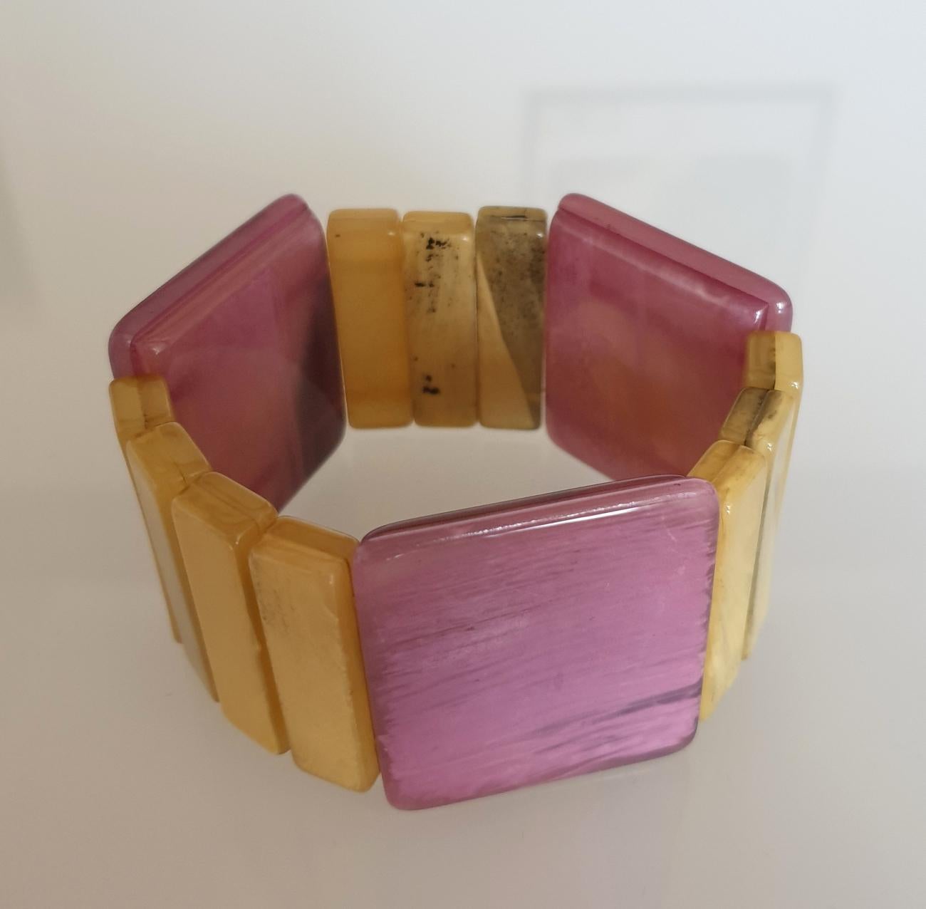 Mid Century Bakelite bracelet, France circa 1970s.
Some black veins on the Bakelite.
The Purple elements are a little higher than the yellow ones, 
giving a lot of style to the bracelet.
Excellent condition.