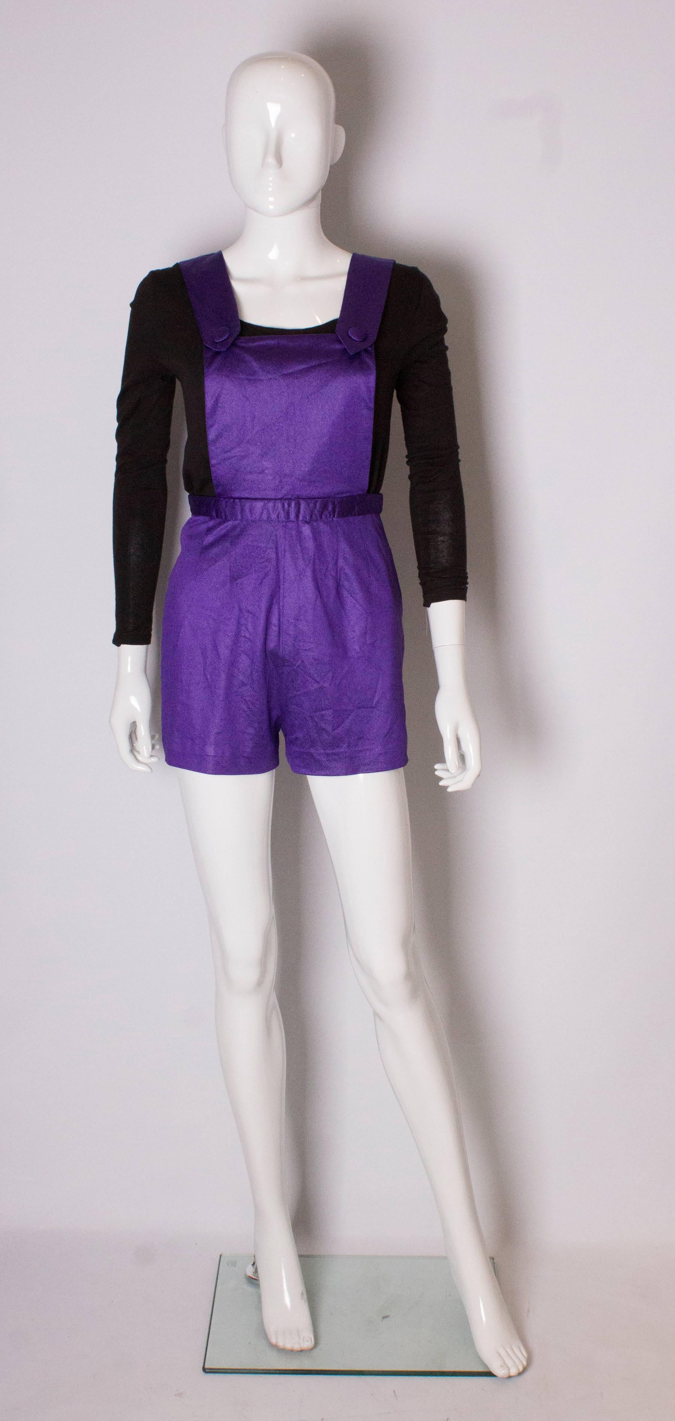 A great short vintage playsuit in purple. The playsuit has a zip opening at the back, and popper studs on the bib.
Bust 34/36'', waist 24'', length  30''