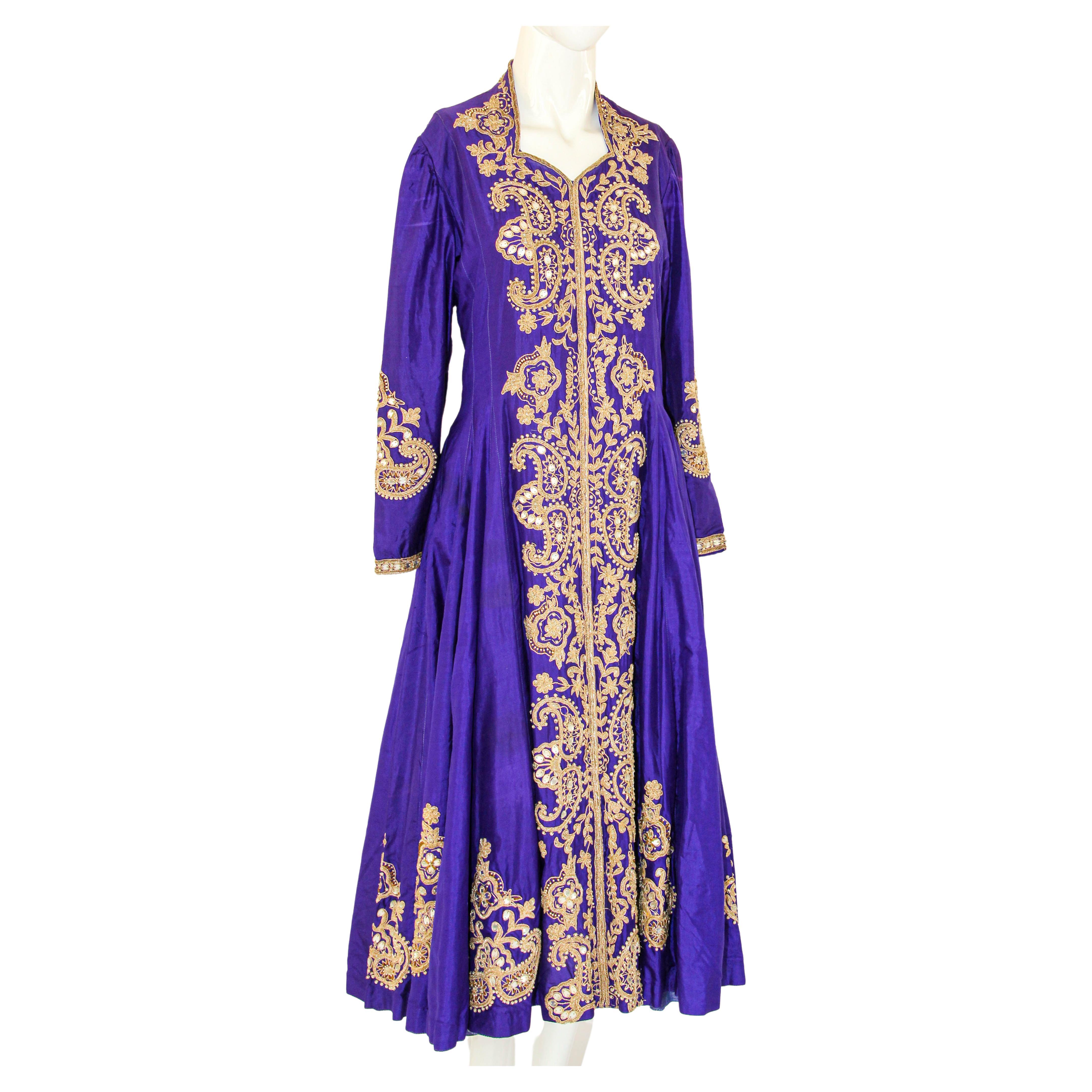 Vintage purple silk maxi dress featuring embroidered zari mor motifs highlighted with sequin work.
Purple silk wedding dress lavender evening dress coat hand embroidered kashmir India.
This luxurious Kashmir dress are world famous for their beauty