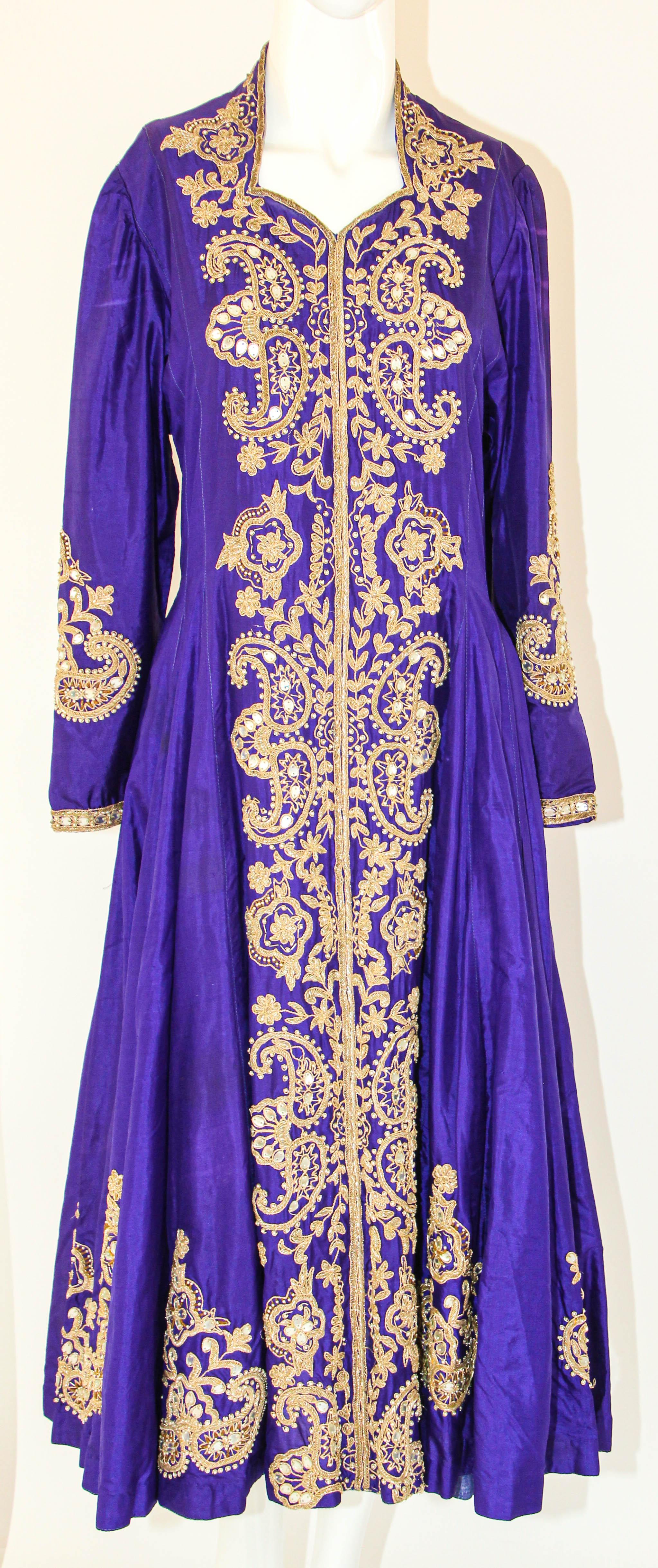 Vintage purple silk maxi dress featuring embroidered zari mor motifs highlighted with sequin work.
Purple silk wedding dress lavender evening dress coat hand embroidered kashmir India.
This luxurious Kashmir dress are world famous for their beauty