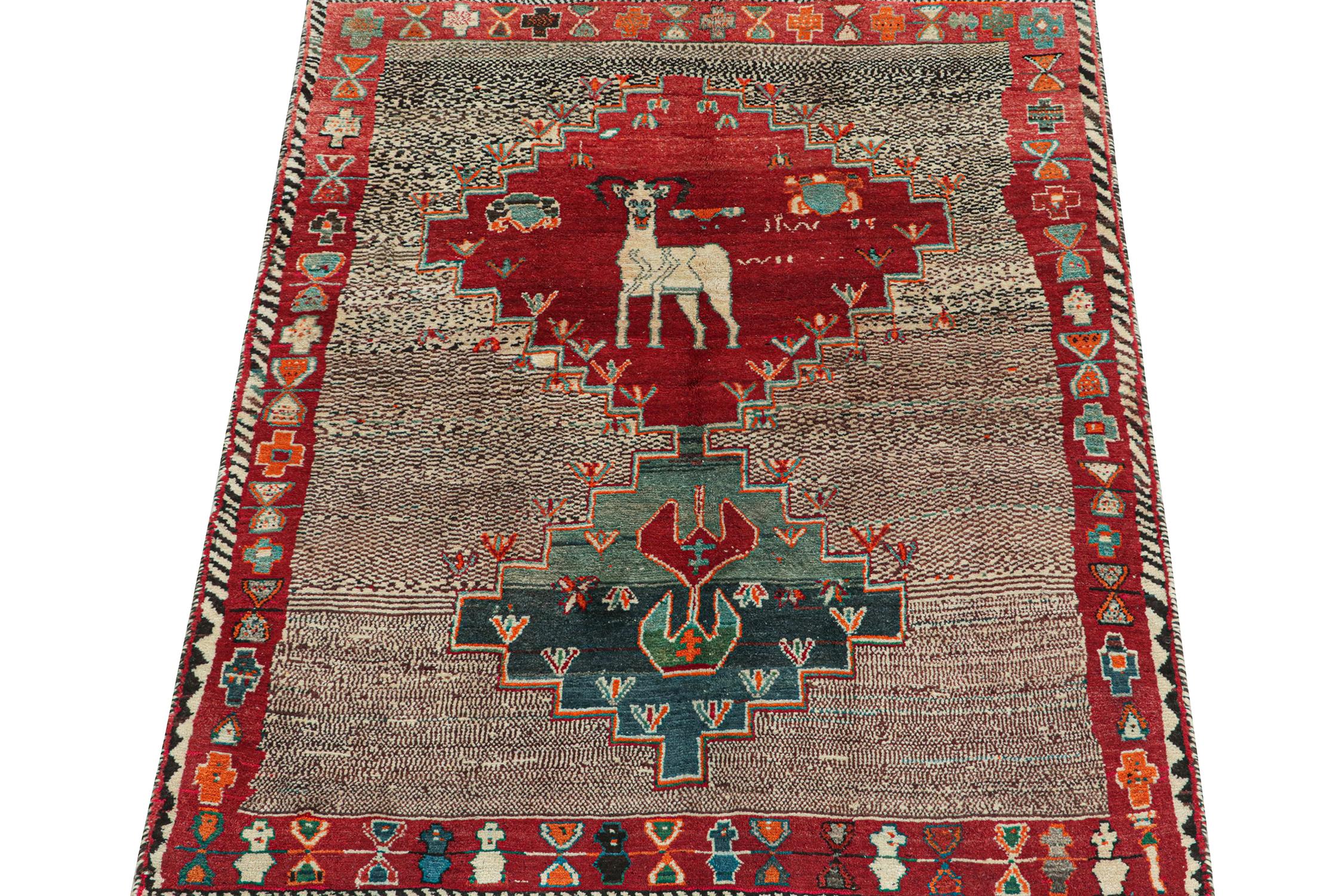 This vintage 5x7 Persian rug is a rare mid-century Gabbeh piece that originates from the Qashqai tribe. 

Hand-knotted in wool circa 1950-1960, its design plays medallion and all-over pattern style together in a bold tribal fashion.

The upper