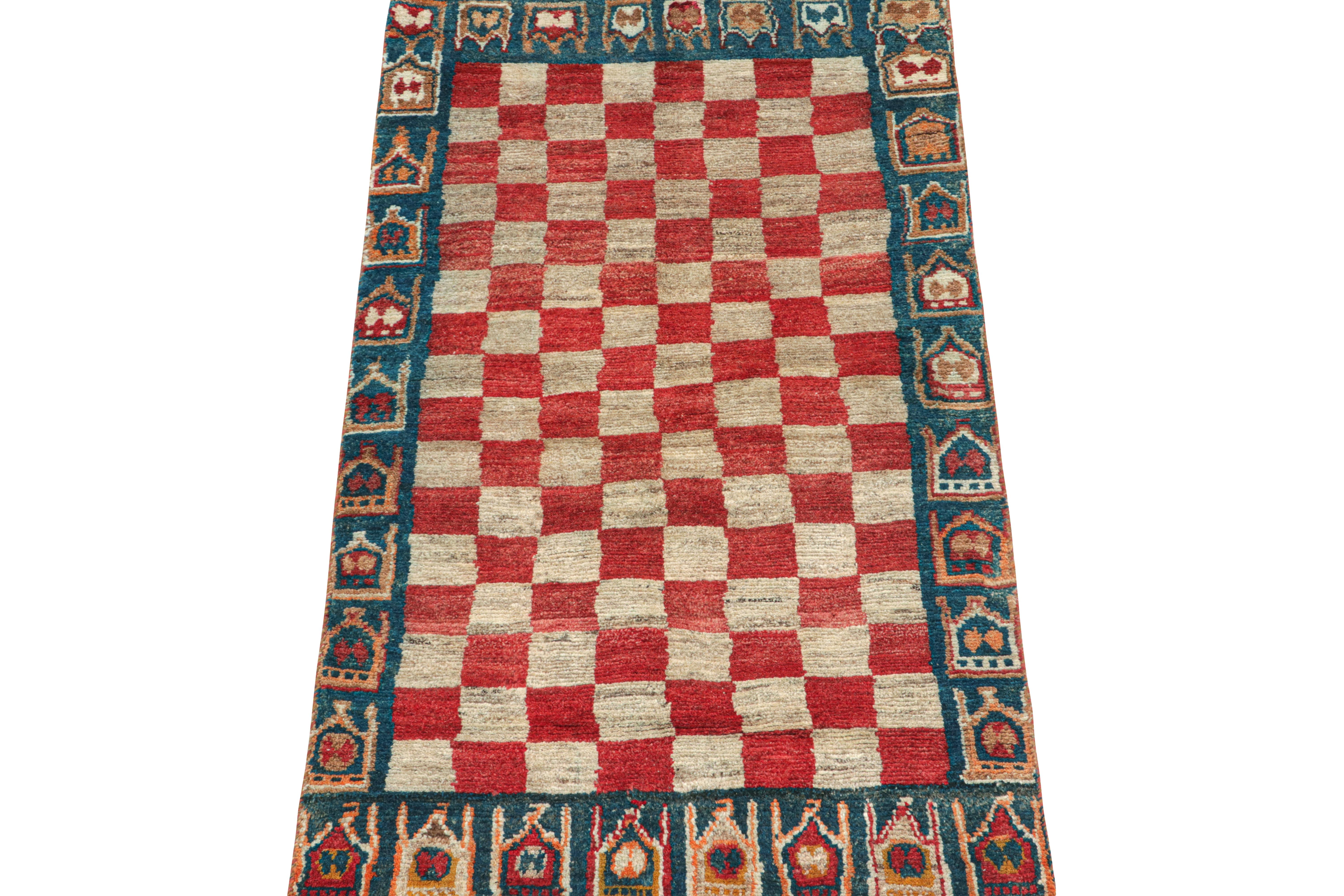This vintage 3x6 Persian runner is a Gabbeh rug that originates from the Qashqai tribe—hand-knotted in wool circa 1950-1960.

Its repeat is a geometric pattern that plays beige and red squares in a checkerboard style. Keen eyes will further admire