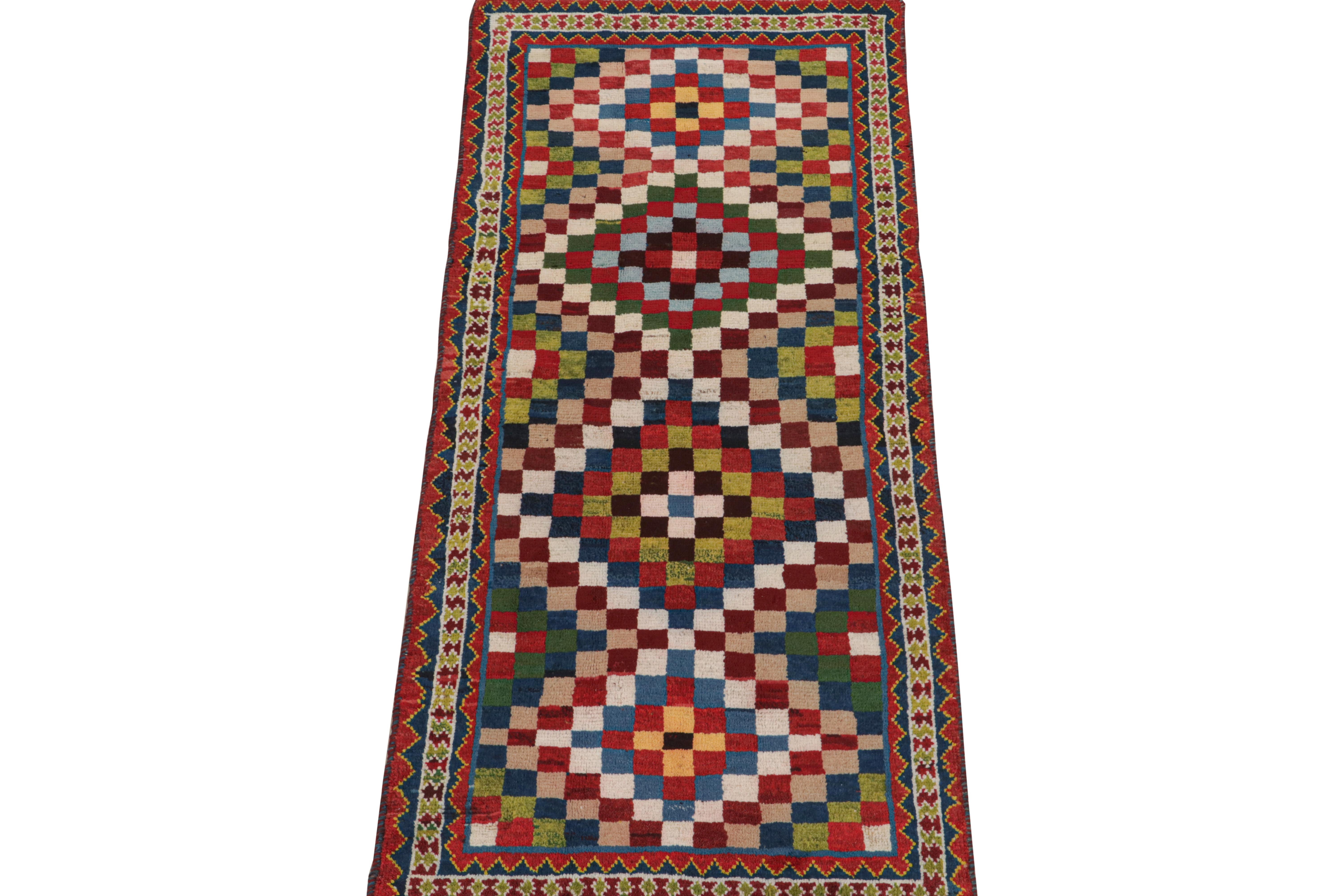 This vintage 3x7 Persian runner is a Gabbeh rug that originates from the Qashqai tribe—hand-knotted in wool circa 1950-1960.

The design enjoys a mosaic-like geometric pattern with vibrant polychromatic colors—especially bright green, blue, and