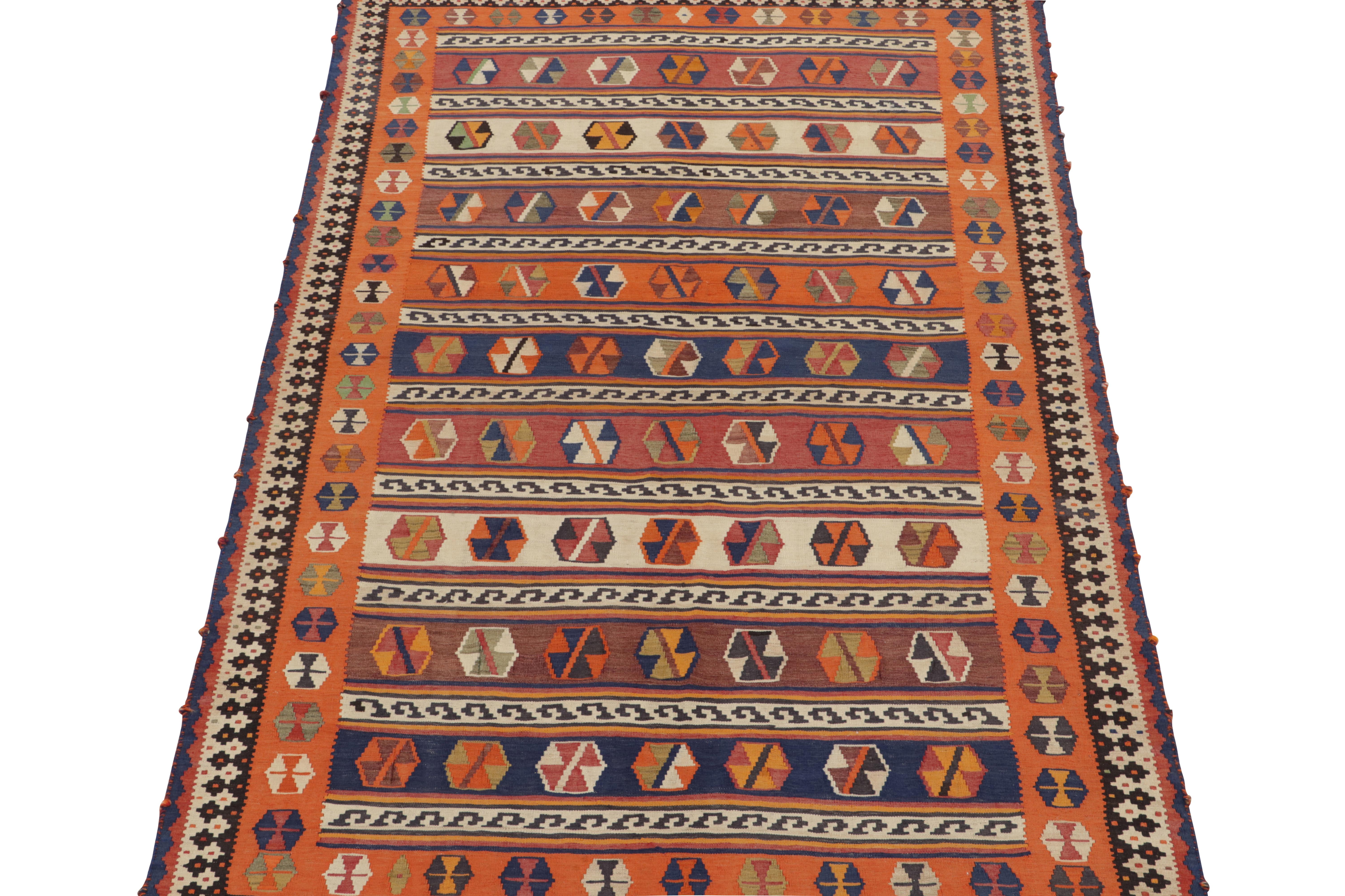 This vintage 5x10 Persian Kilim is a midcentury flat weave believed to originate from the Qashqai Tribe. 

Handwoven in wool circa 1950-1960, its design favors vibrant orange and blue in the wide range of warm colors it hosts. Keen eyes will