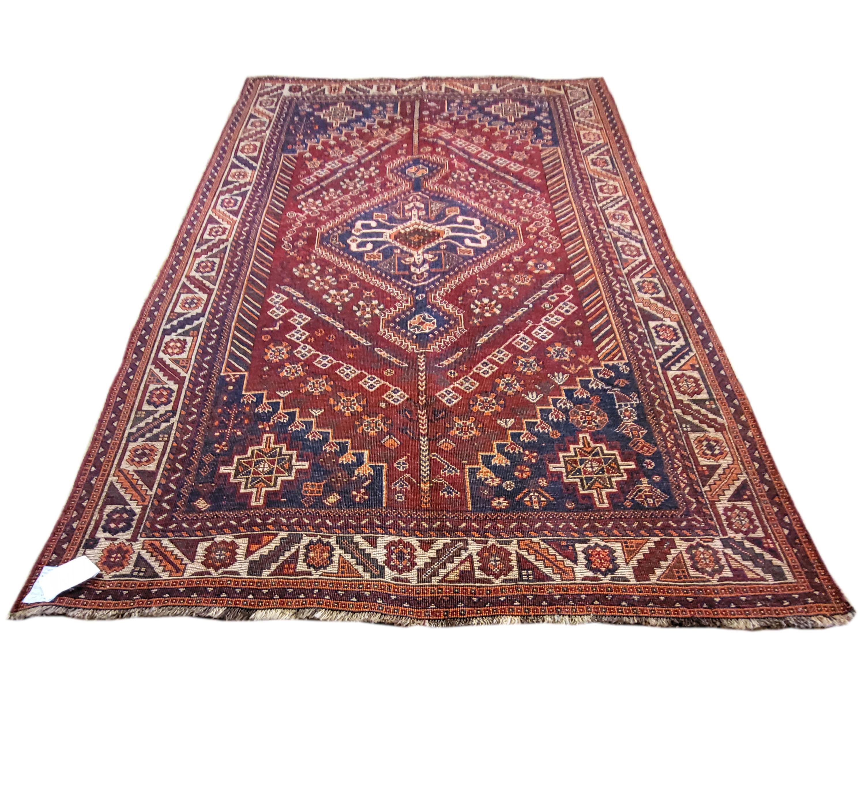 Gorgeous 100% wool tribal rug. Woven by a subtribe of the Qashqais known as the Rahimis, the richness in heritage is matched by it's intricate design. This one of a kind piece is something to behold; full of motifs, patterns, and shimmering vibrant