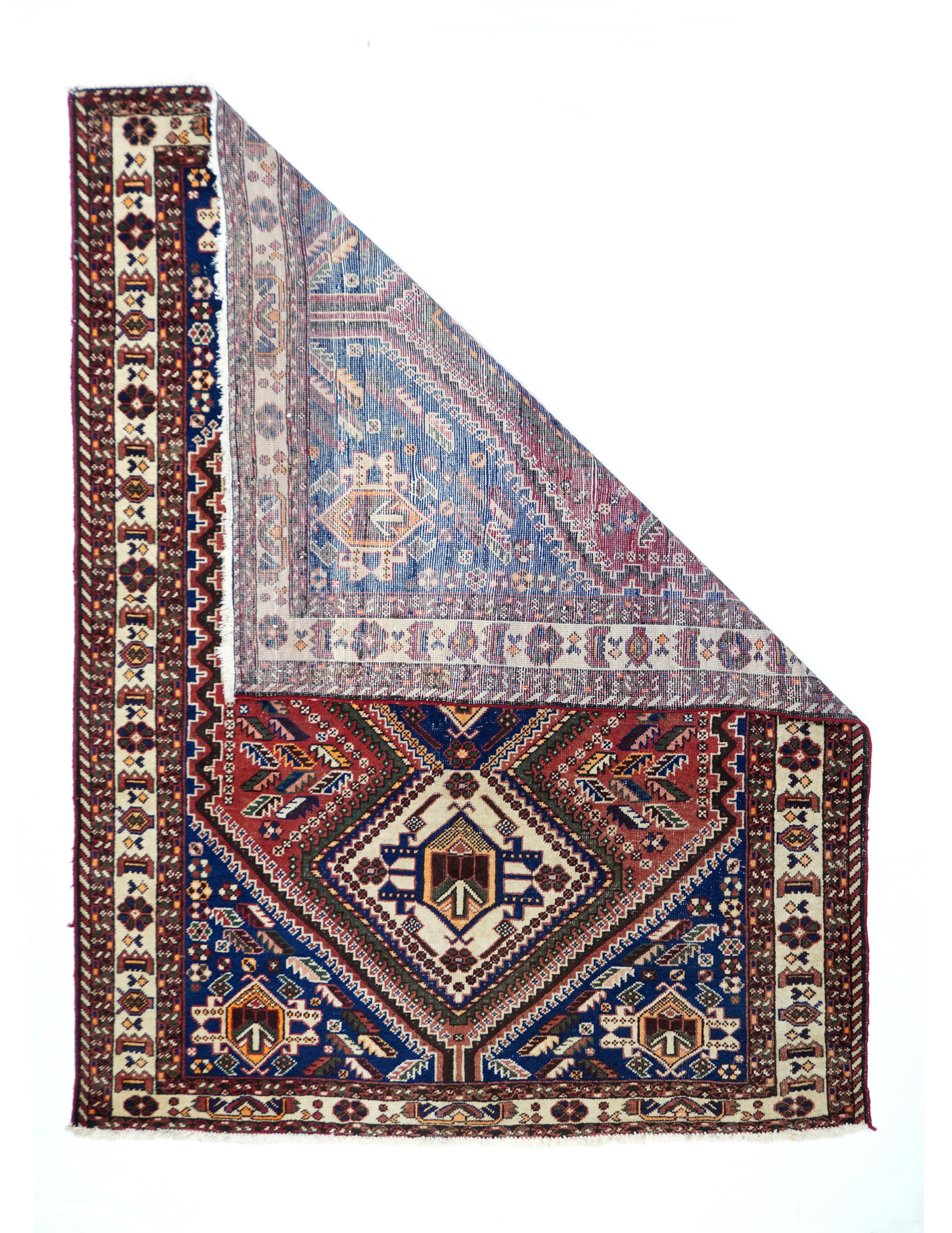Vintage Qashqai rug¬†5' x 6'11''. A pole medallion of three bnest4ed, stepped, conjoint octagons in old ivory and royal blue, with angular 