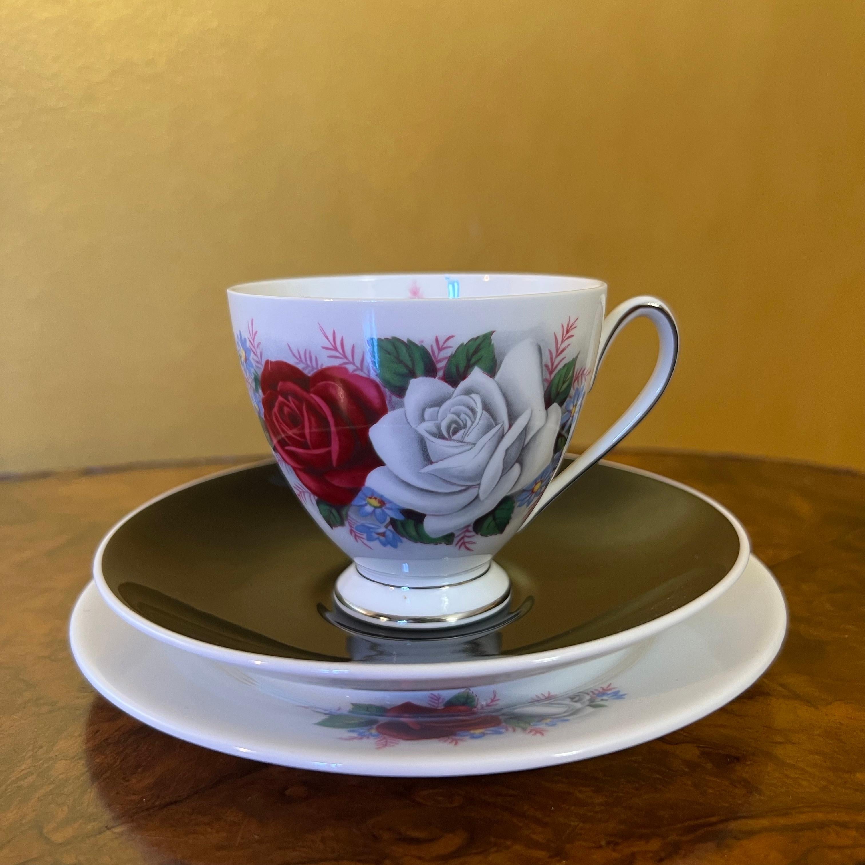 Description: Red and white rose print with silver trimming, some ware to items.

Circa: 1960s

Material: Porcelain

Country Of Origin: England

Measurements

Cup: 7.5cm high, 10cm length, 8cm width

Saucer: 14cm diameter

Side Plate: 15.5cm diameter