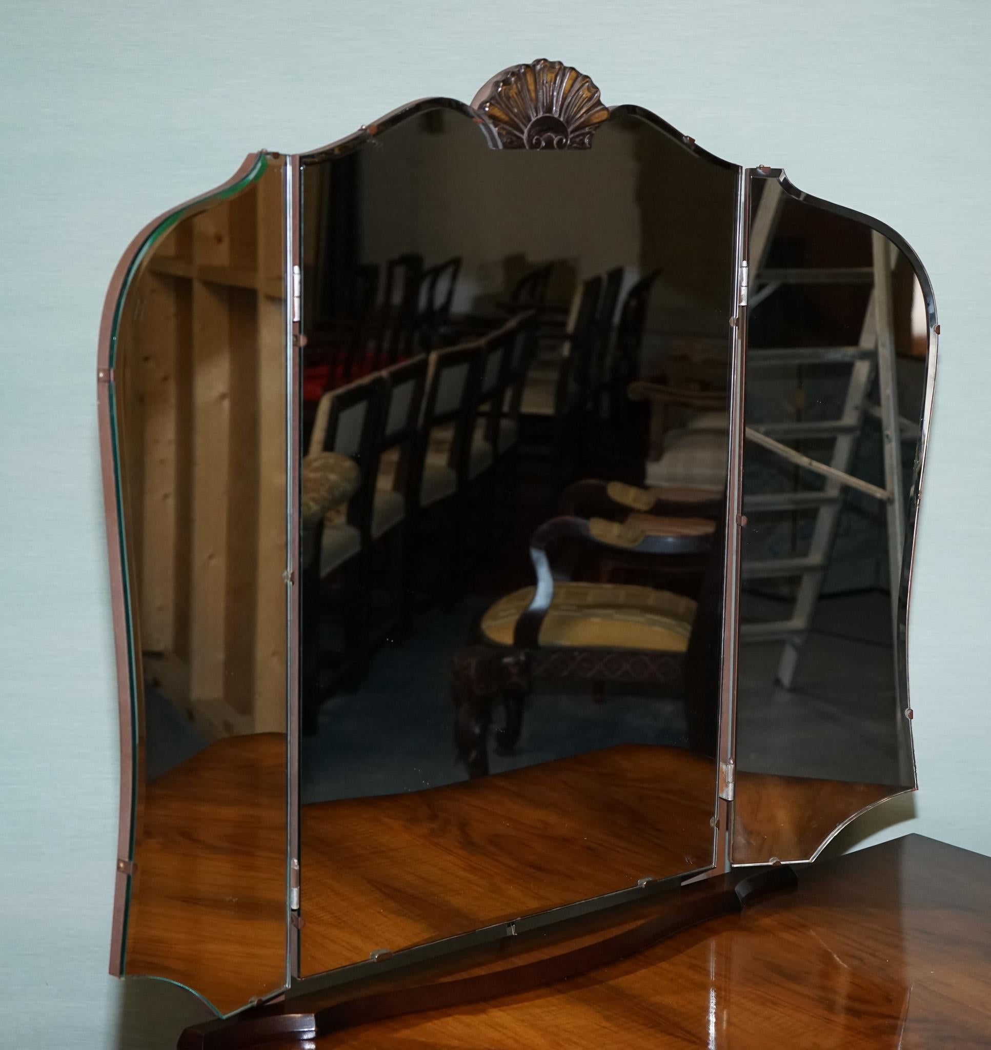 
Antiques of London



This elegant dressing table in the Queen Anne style features a stunning hardwood with a rich, warm finish. The serpentine front is complemented by six drawers, each adorned with decorative brass handles, offering practical