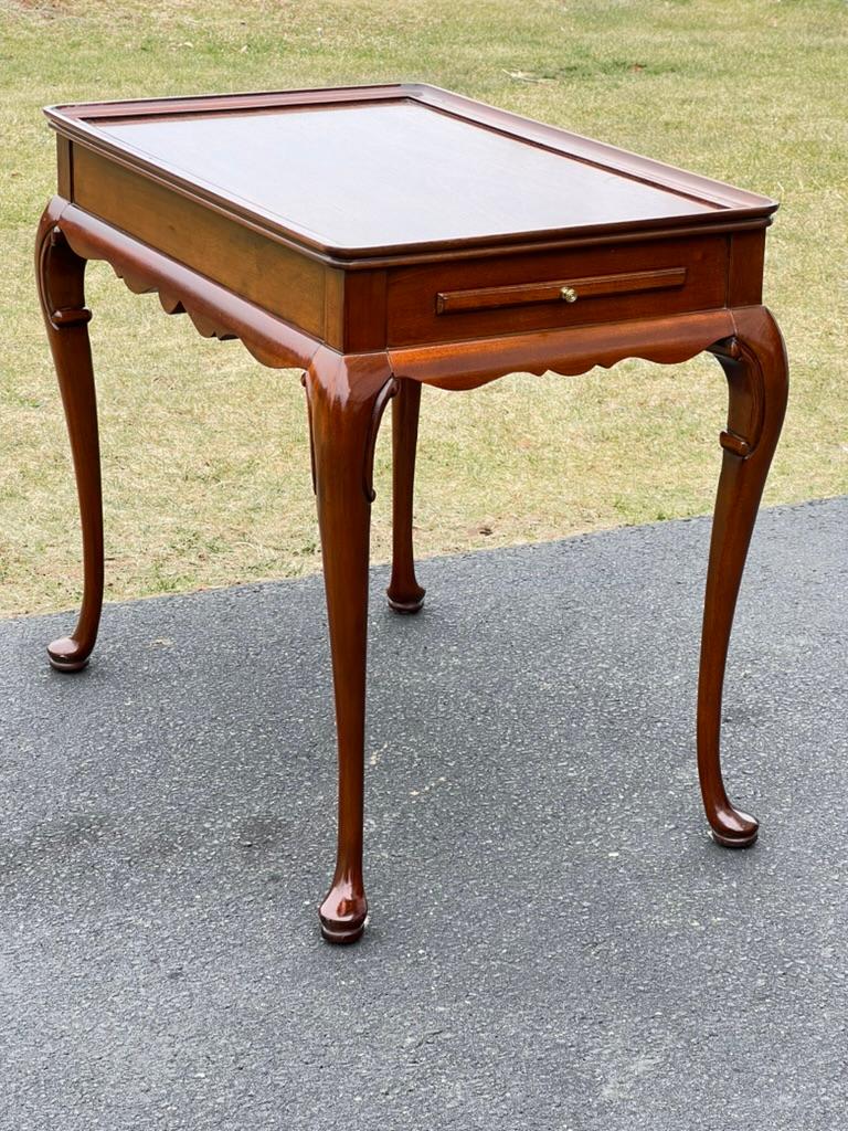 Introducing a Vintage Queen Anne Style Mahogany Tea Table, a timeless piece that exudes elegance and sophistication. Crafted from rich mahogany wood, this tea table features graceful Queen Anne legs with delicate curves and cabriole feet,