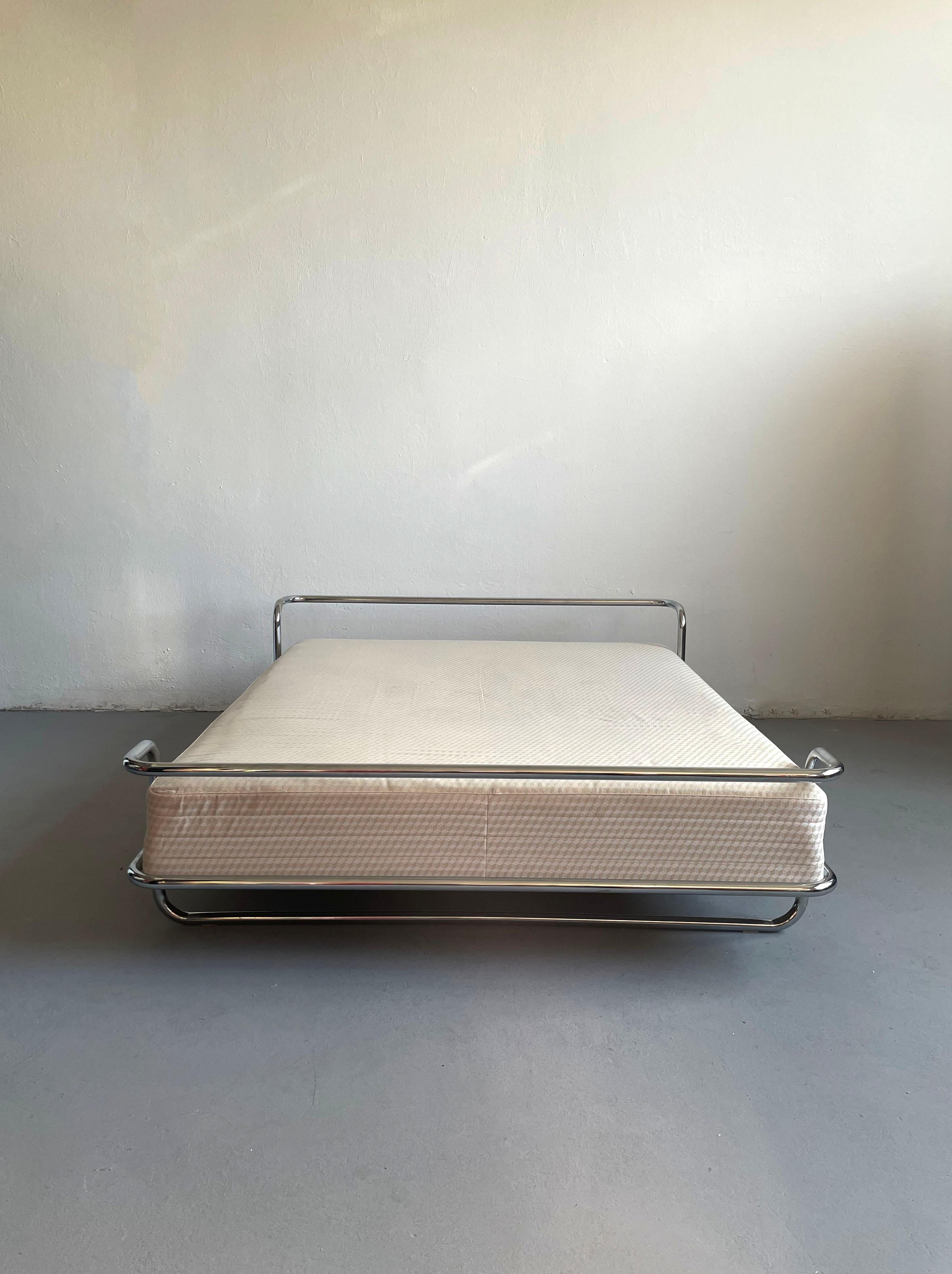 Chrome king-size bed with original SULTAN mattress, designed by Knut Hagberg, c.1982. The modernist form takes clear inspiration from Swedish architect Bruno Mathsson’s 1974 Ulla bed. Designed to compliment the best-selling SULTAN box spring