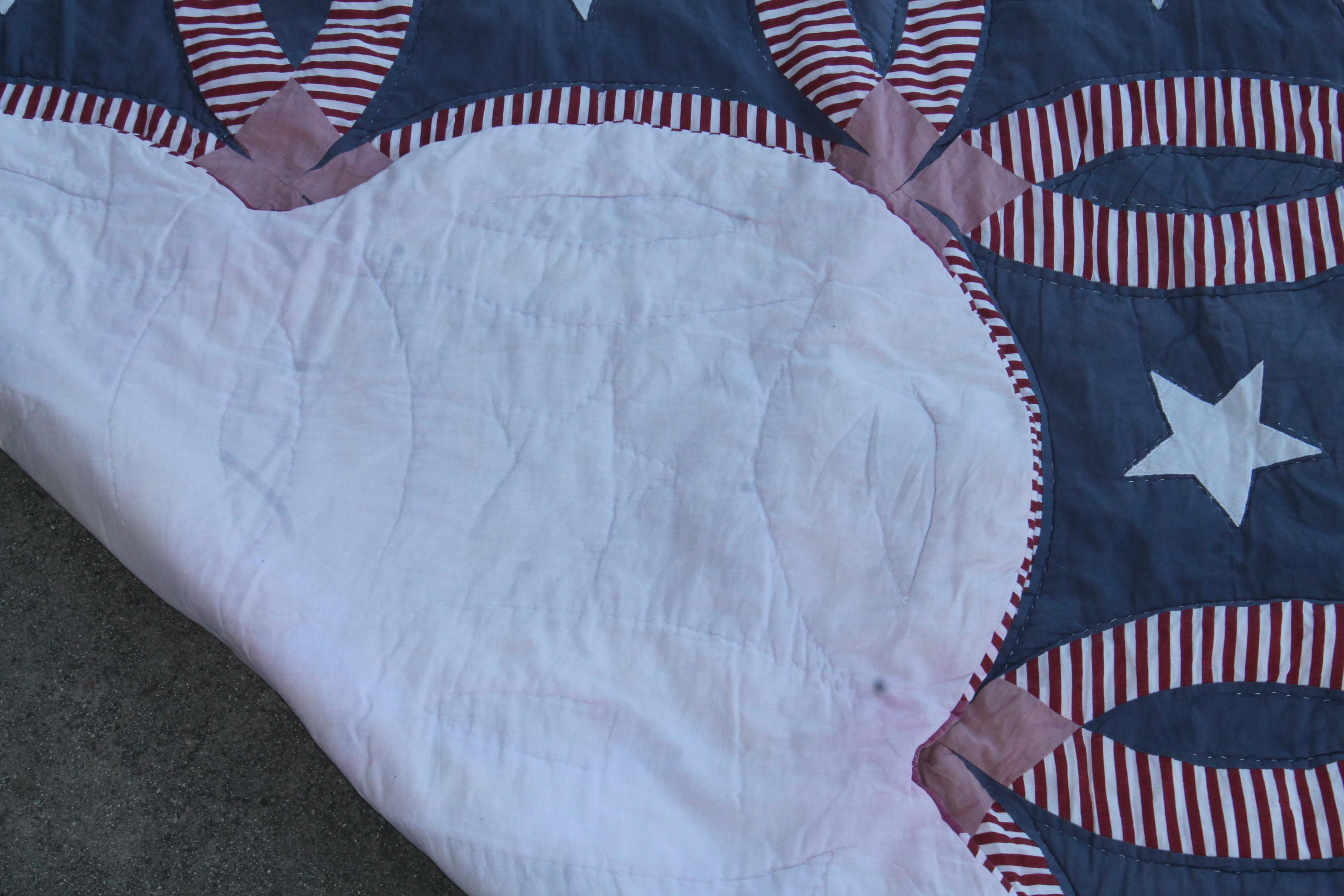 This fun and folky patriotic wedding ring quilt with a overall fade throughout. The condition is very good with no damage.