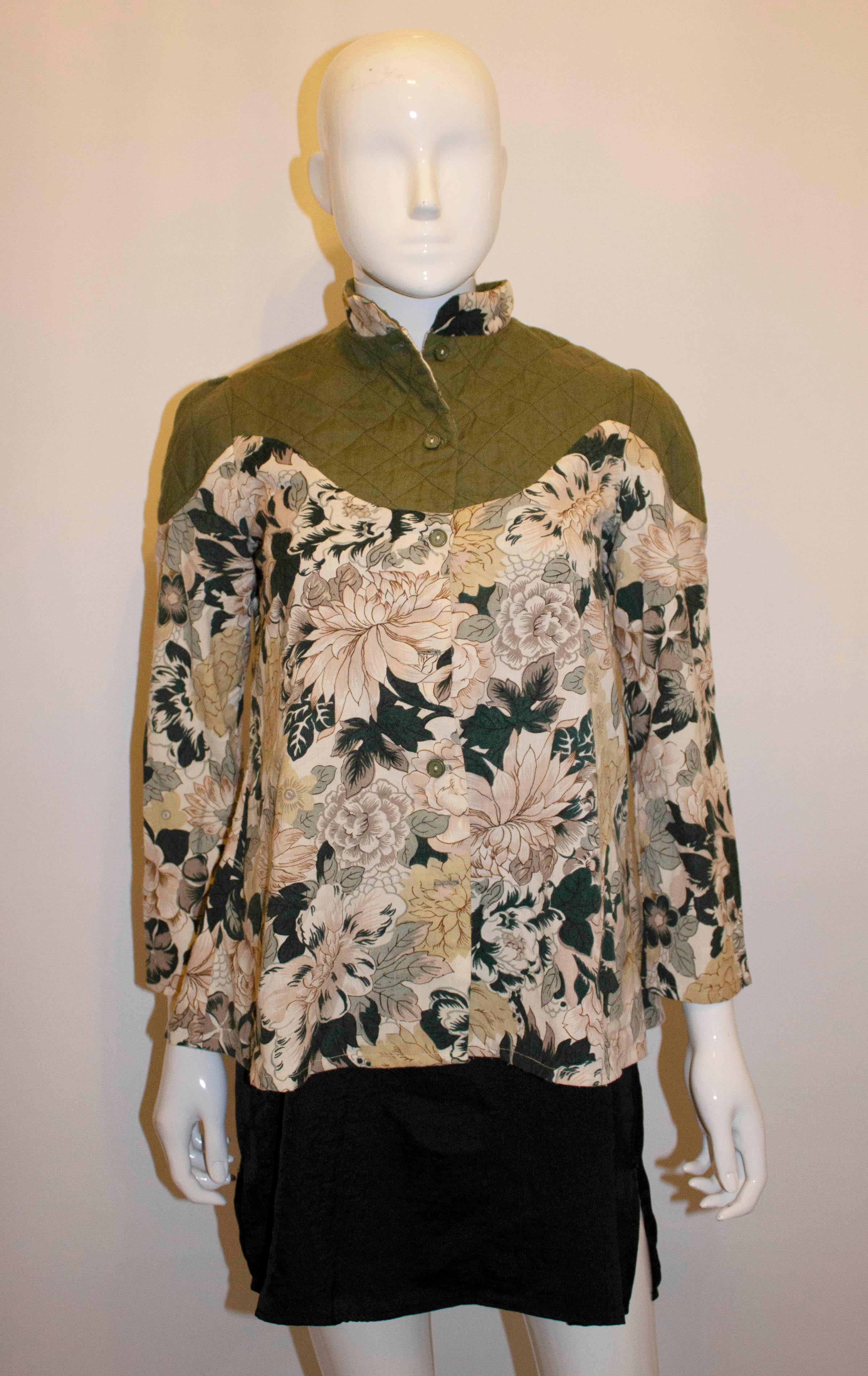An unusual vintage top for Fall. The top has a sage green quilted top and yoke with a printed body and sleaves, It has a front button opening , stand up collar and is unlined. 