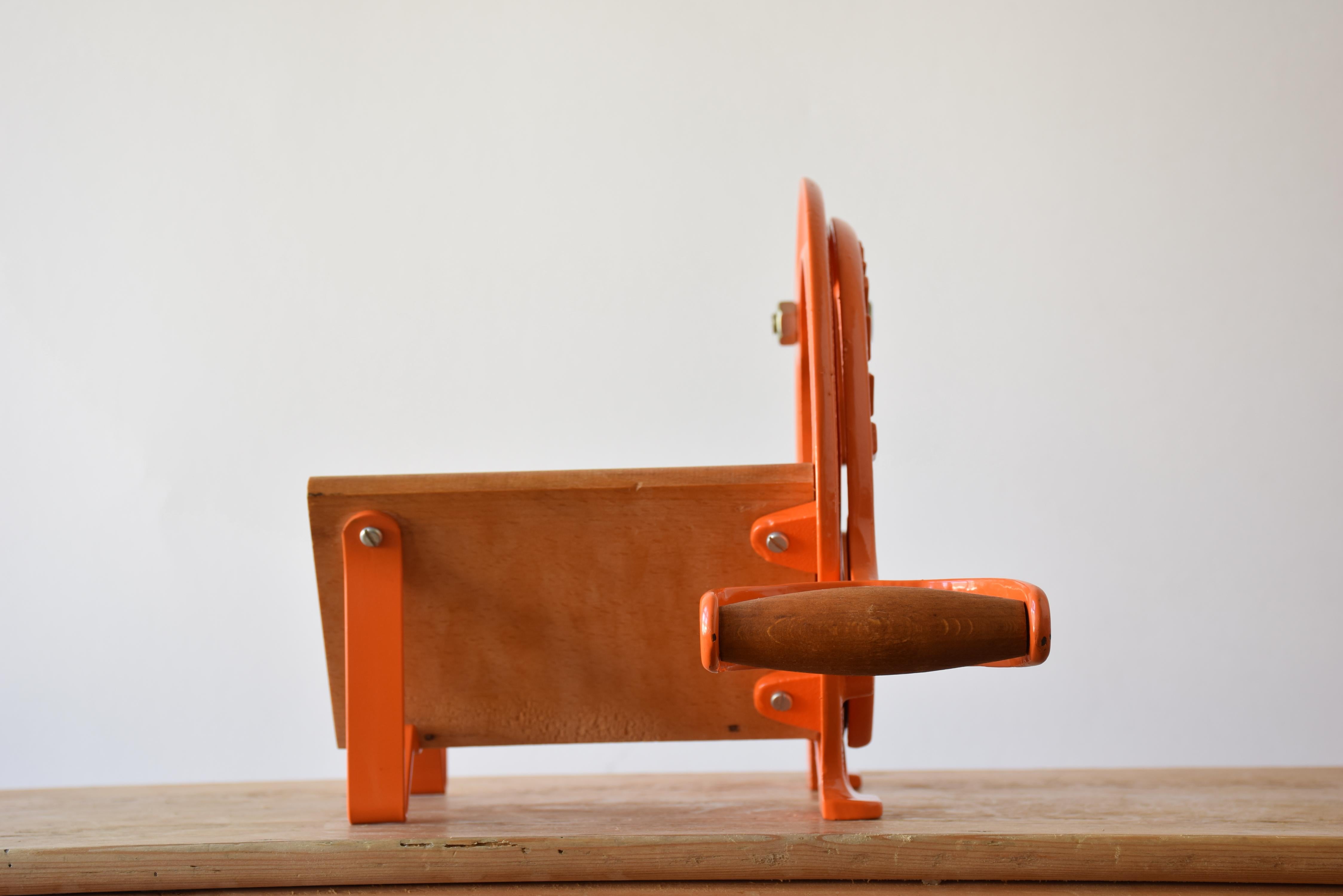 This iconic Danish bread slicer was produced by Raadvad in Denmark, circa 1970s-1980s. It comes with the original orange paint. The bread slicer is fully functional for slicing bread, especially black bread and firm bread and is at the same time