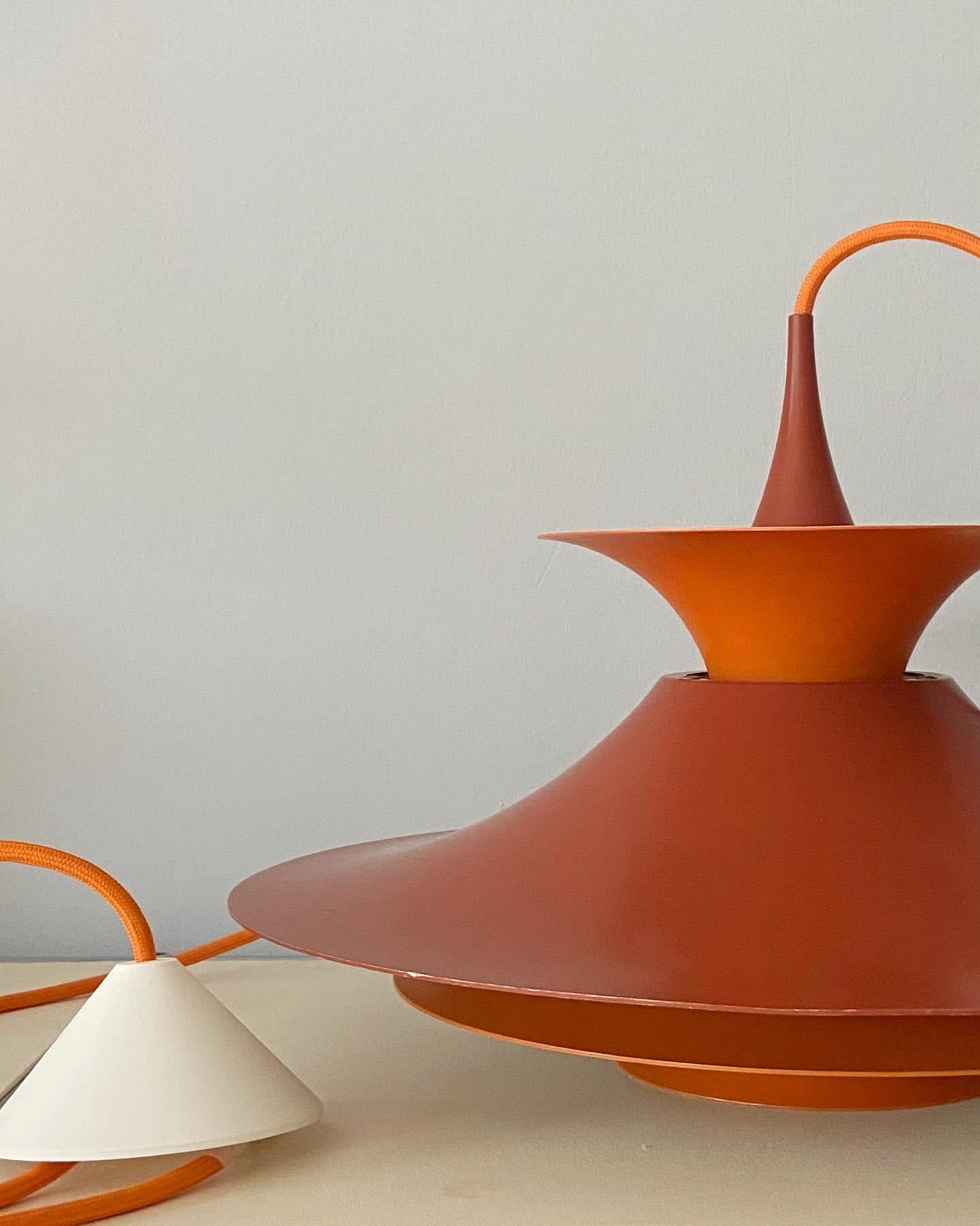 Radius 1 pendant by Erik Balslev. Red and orange shades inside white lacquered aluminium. Produced by Fog & Mørup. Measures: 47 cm diameter version with E26/27 Edison socket. No parts missing (with reflector) ! With new orange fabric cord. Ready to