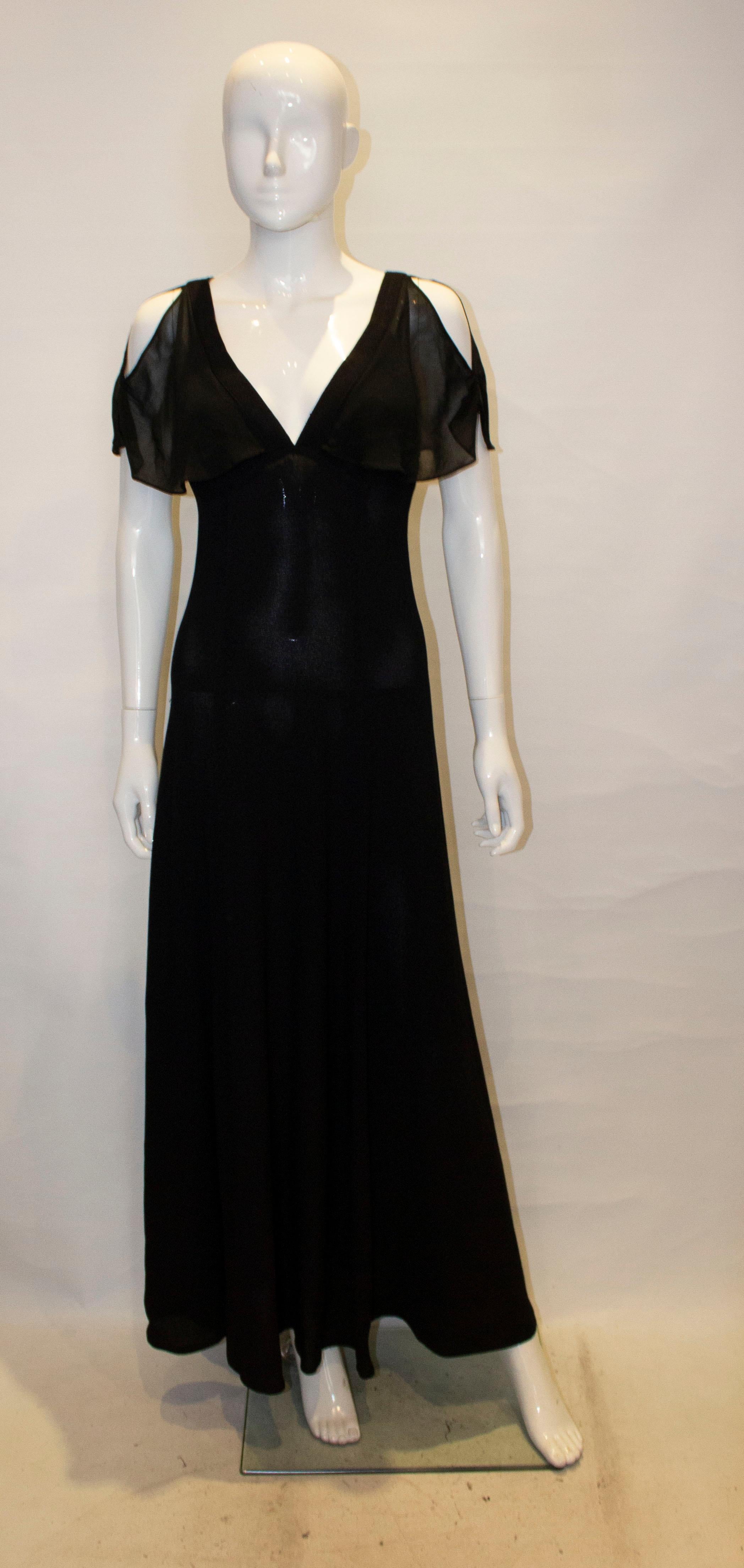 A pretty vintage evening dress by Radley in their signature moss crepe.  The dress has a v neckline  and backline with central back zip and shear cap sleeves.