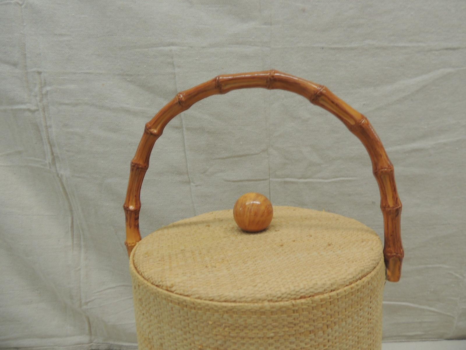 Vintage Raffia covered round ice bucket with bamboo handle.
Plastic liner inside.
Size: 7.5