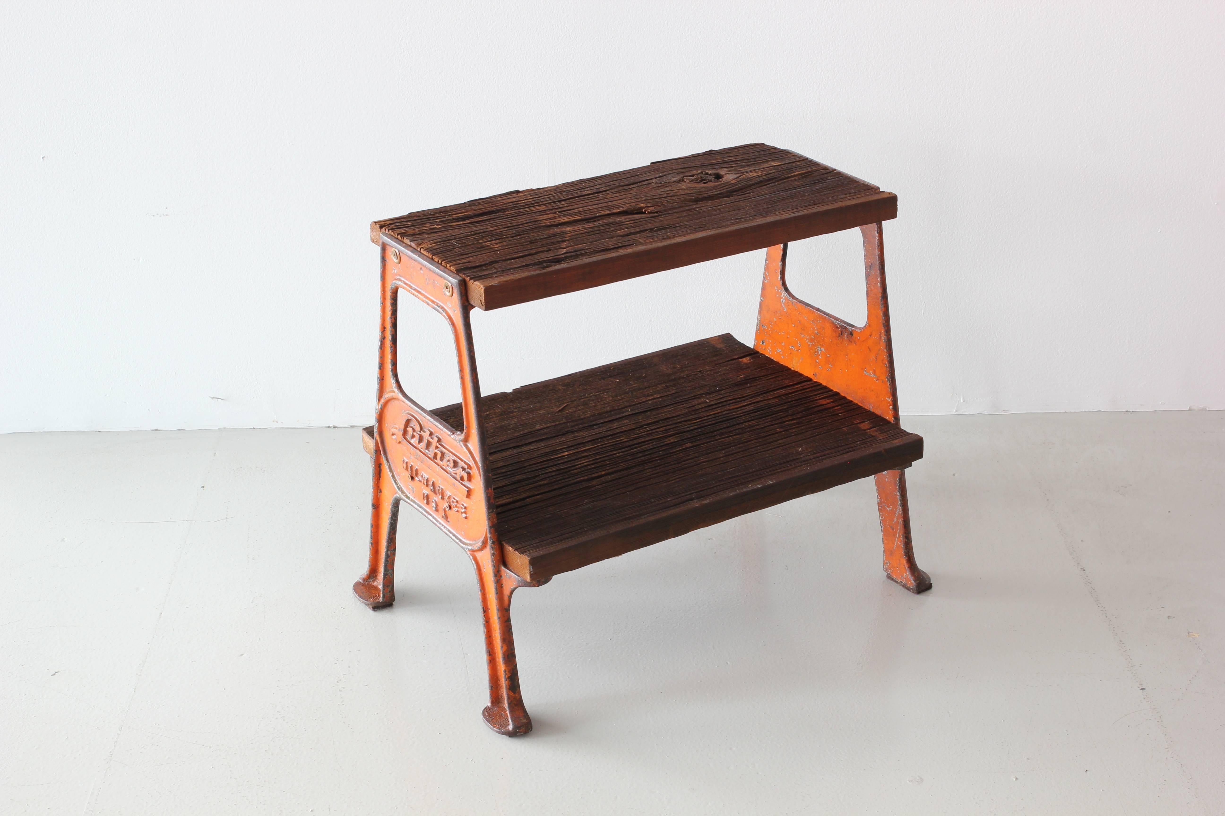Great vintage railroad step stool with original orange painted steel frame and raw wood steps. Fantastic chipped paint on frame that reads 
