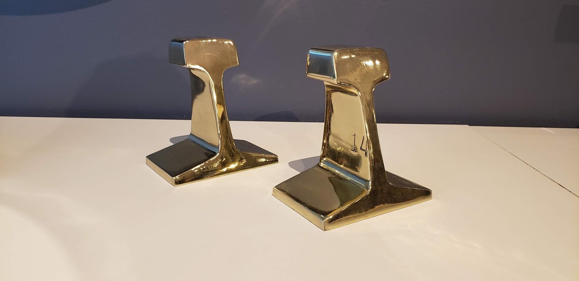 Stunning mirror-polished brass plated iron railroad tie bookends, circa 1970s. Very heavy. Excellent condition with very minor wear. These show beautifully and are quite large--great statement pieces!

6
