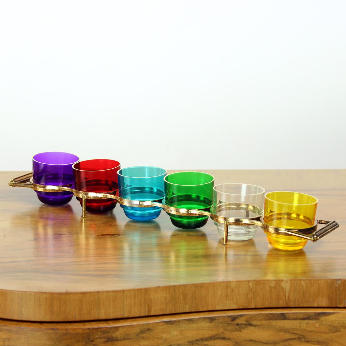 Beautiful vintage set of shots in rainbow colors in one holder. The piece is made of plastic, a very popular material in 1960s. But the condition is really nice. Apart from some age signs, there is no damage to the shots or the holder. Fully