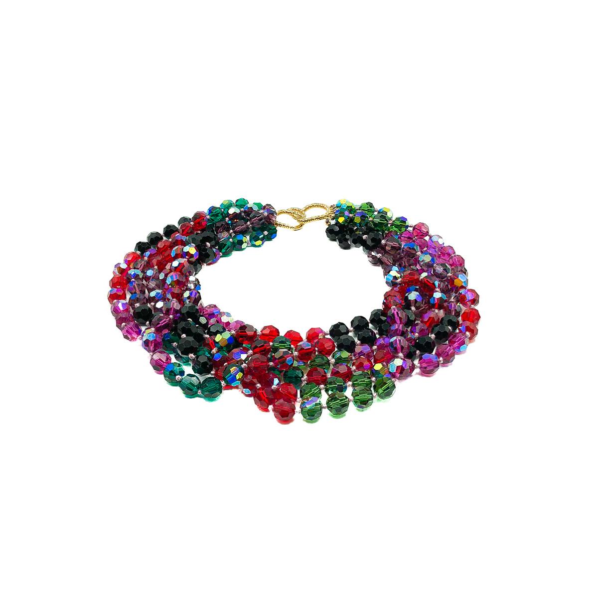 A striking Vintage Rainbow Torsade Collar of the most stunning quality. Crafted with six strands of individually knotted, Swarovski Aurora Borealis Crystal beads in purple, green and red. Finished with a gold plated loop style rhinestone set feature