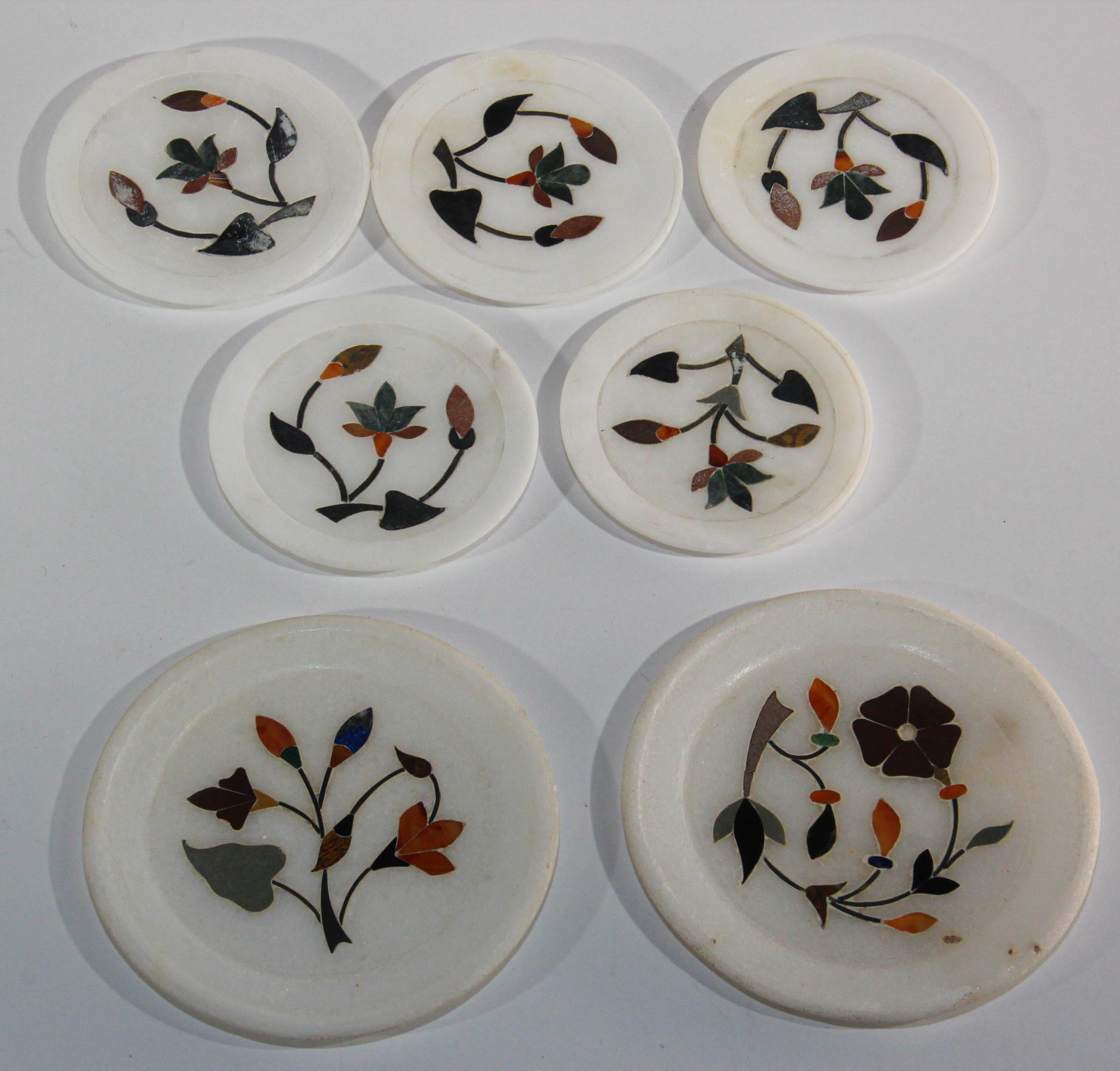Vintage Rajasthani Pietra Dura White Stone Inlay Taj Mahal India Style coaster plates.
Rajasthani inlaid stone marble decorative set of 7 small round plates in Pietra Dura work.
Beautiful handcrafted coasters in marble inlaid with semi precious