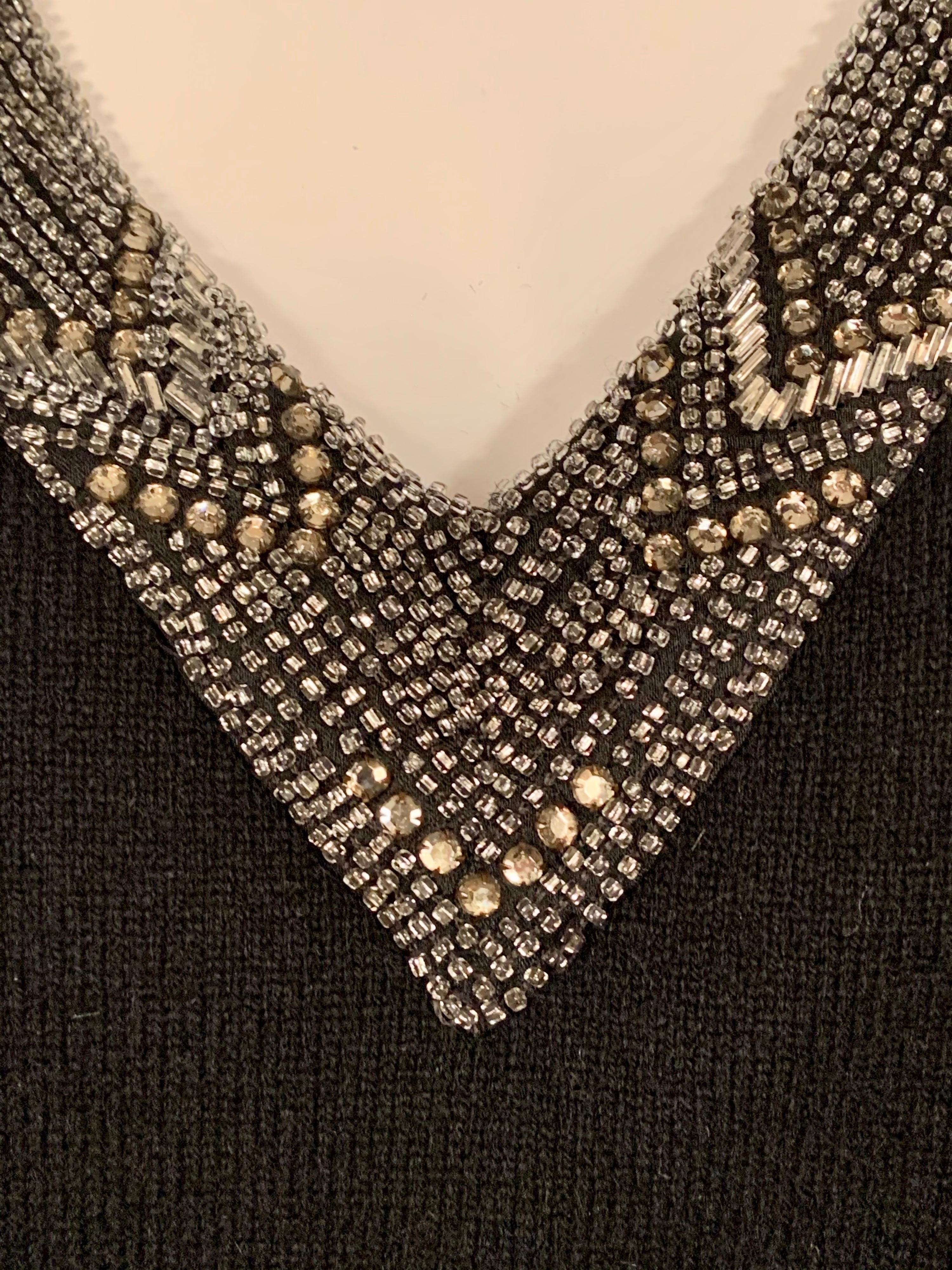 A fabulous vintage cashmere sweater from Ralph Lauren has gorgeous beadwork all around the V neck. Glamour and comfort, hat more could you ash for? It is marked a size Medium and is in excellent condition.
Measurements;  Shoulders 10