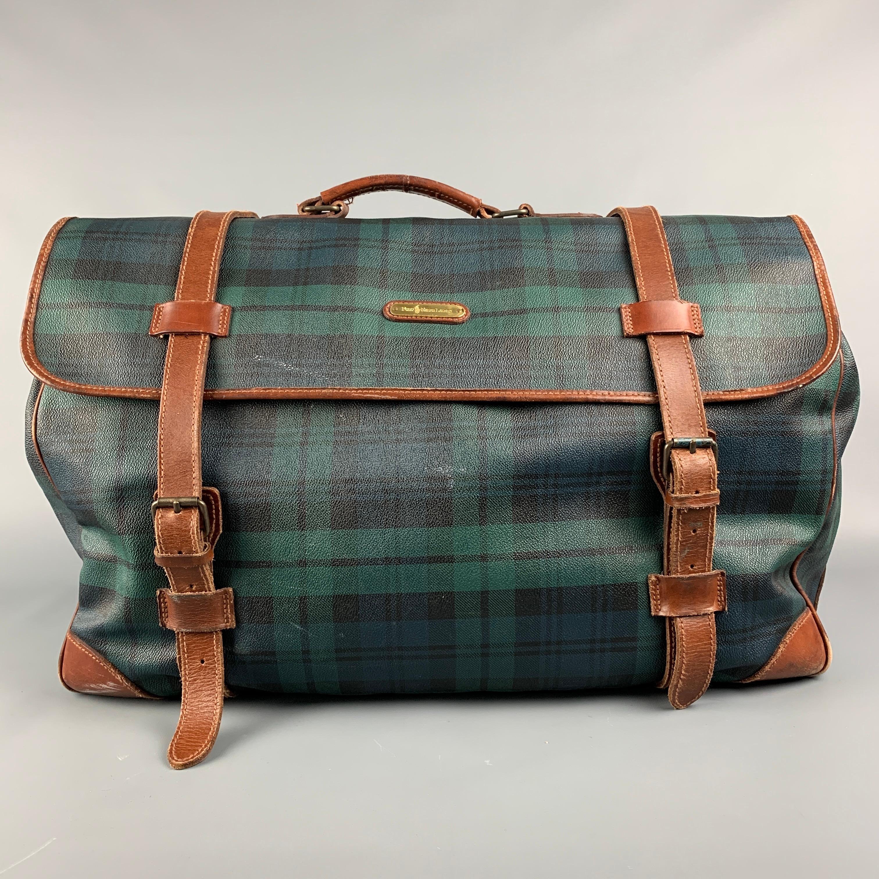 Vintage RALPH LAUREN bag comes in a green & black blackwatch coated canvas featuring a weekender style, leather trim, top handles, inner slots, and a double buckle strap closure. Includes brush. 

Good Pre-Owned Condition. Light marks