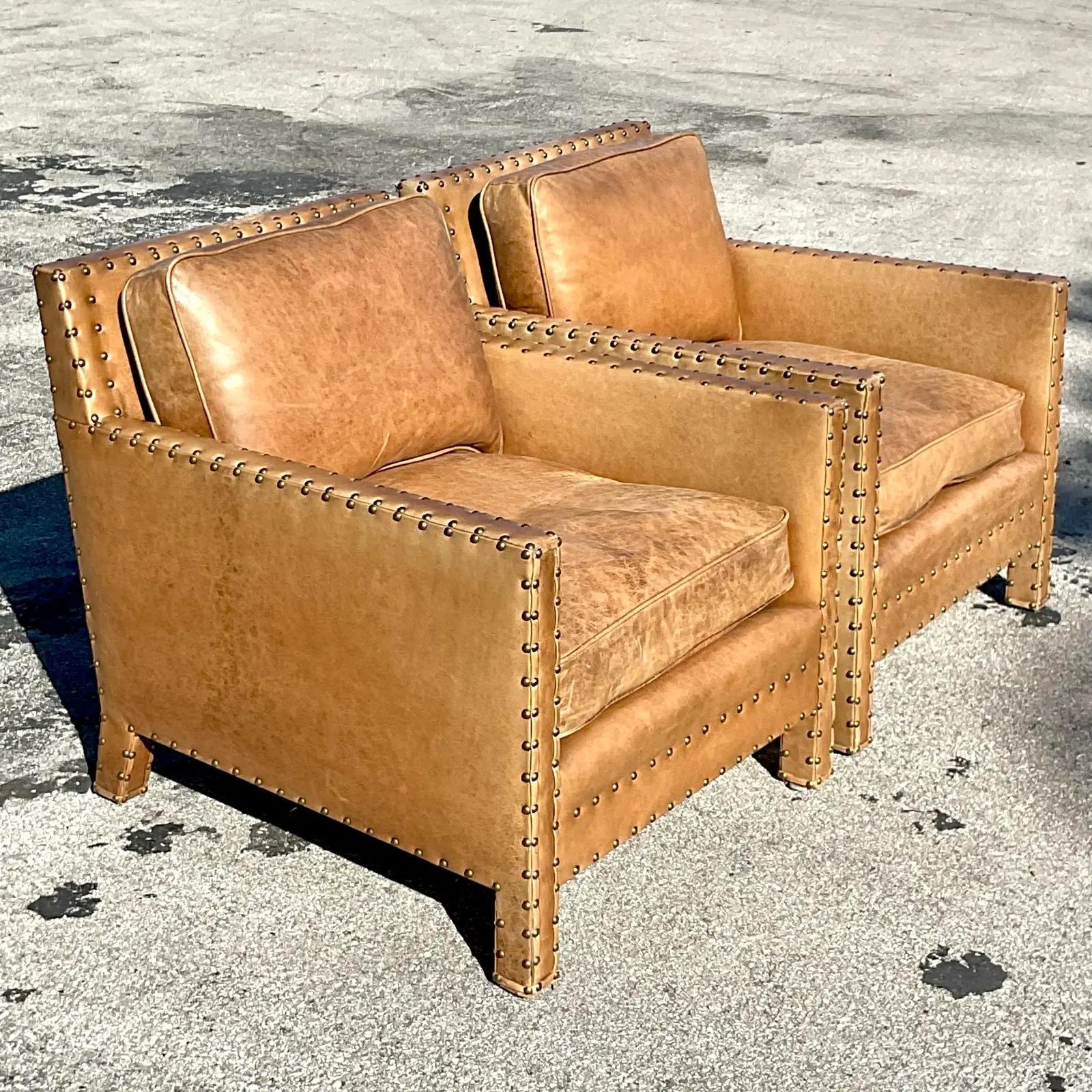 An exceptional pair of vintage Boho leather lounge chairs. Made by the iconic Ralph Lauren. Beautiful distressed leather with chic nailhead trim. Signed. Acquired from a Palm Beach estate.