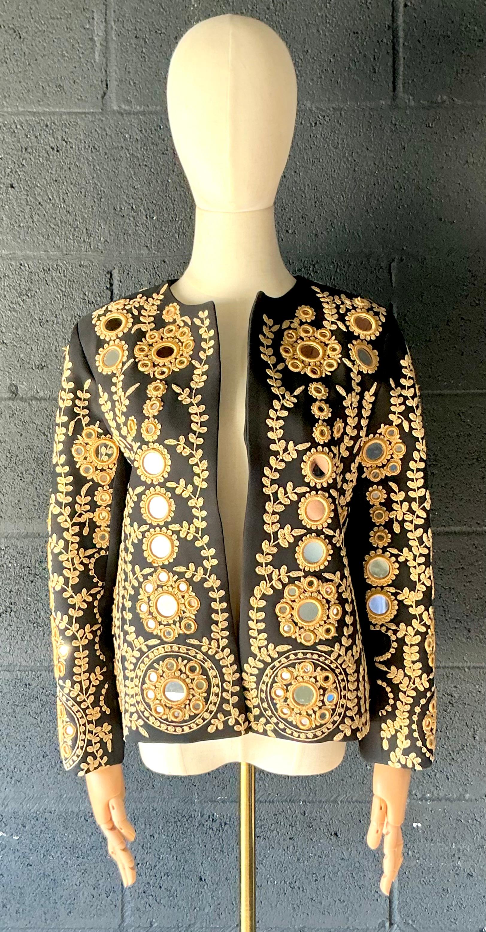 Die Vintage Ramon Filip Black Mirrored Jacket ist eine zeitlos elegante Kombination aus klassischer Schneiderkunst und modernem Design. Dieses mit viel Liebe zum Detail gefertigte Stück verfügt über spiegelähnliche Akzente, die bei jeder Bewegung