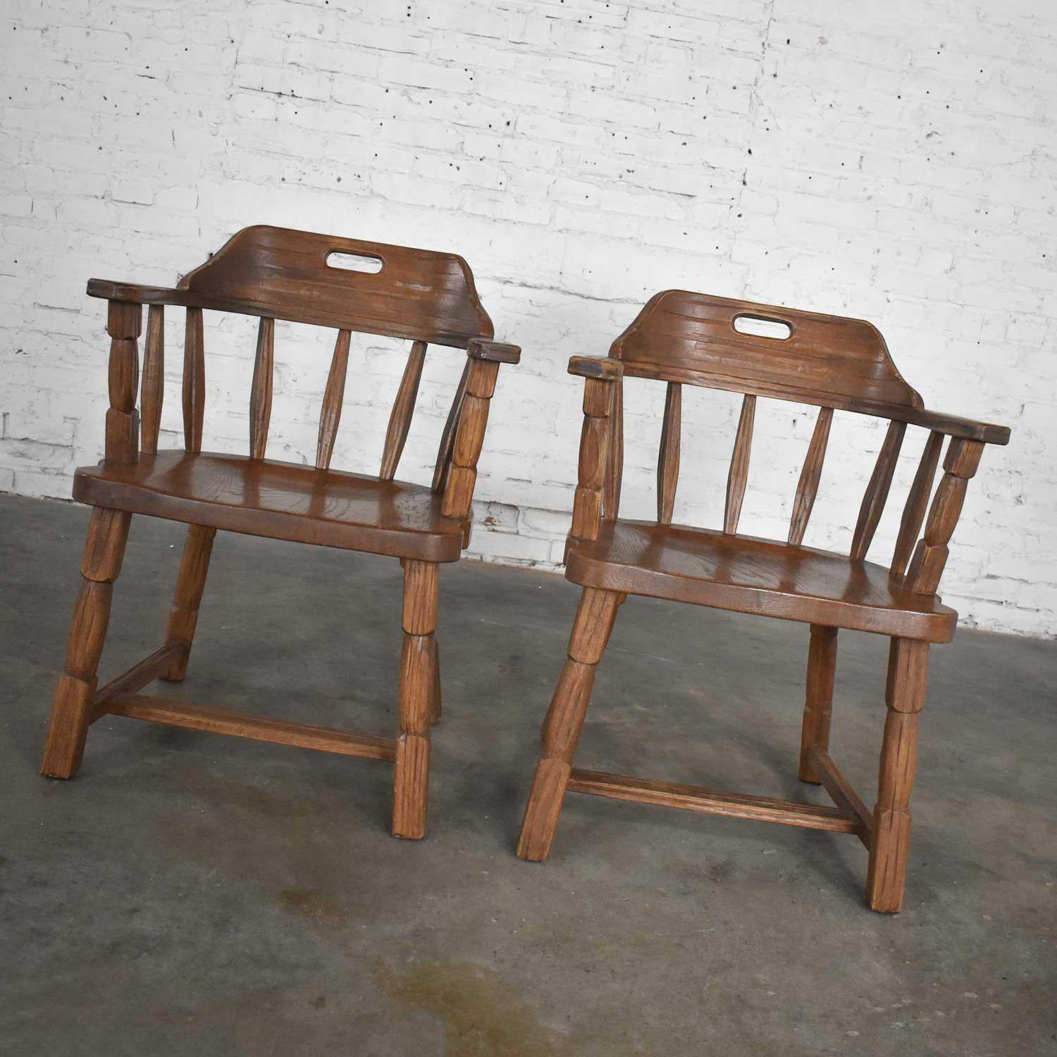 Wonderful pair of vintage captains’ armchairs by A. Brandt comprised of solid ranch oak with acorn brown finish. Gorgeous vintage condition. The arm joints have been tightened and the finish has been restored but is original. Please see photos,