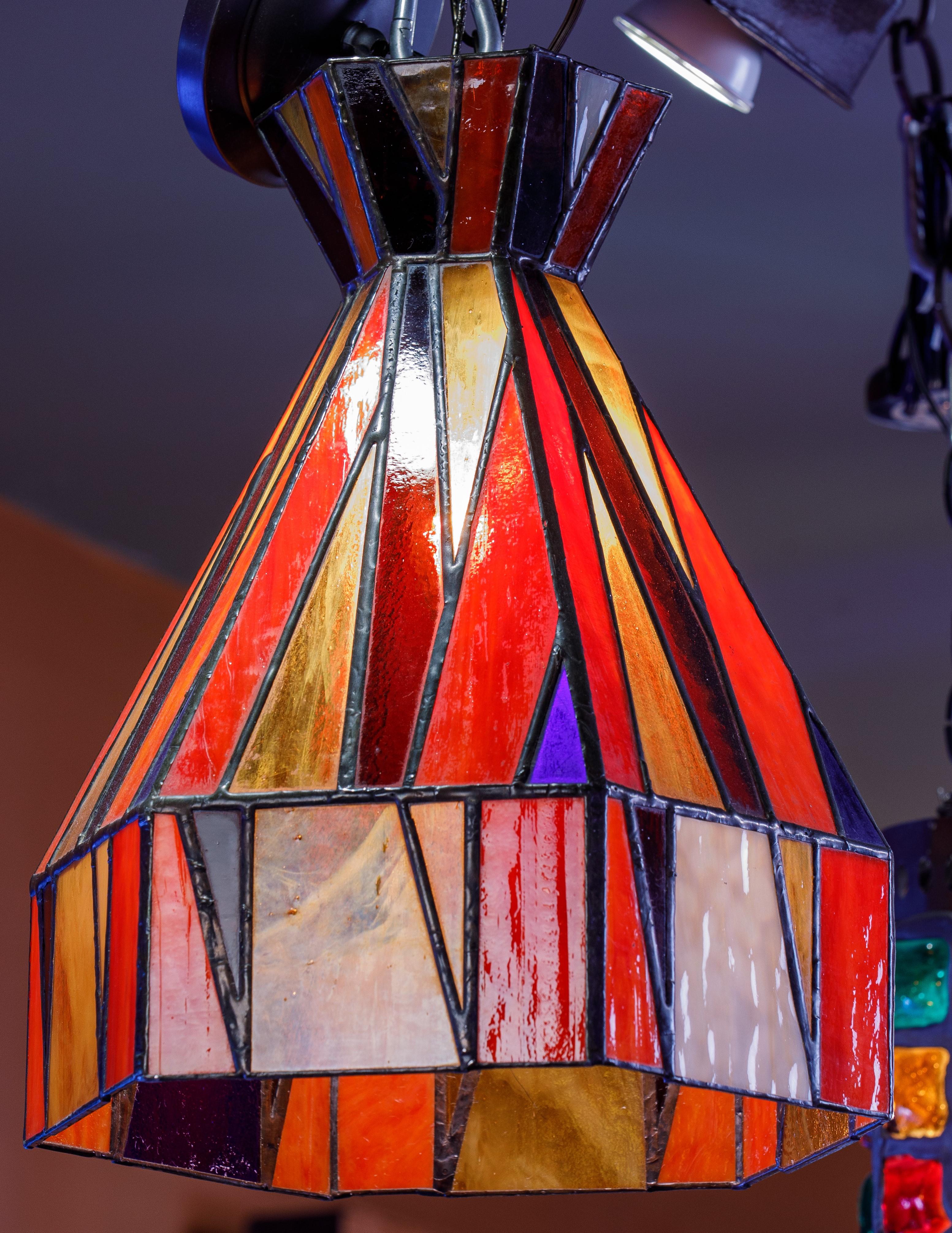 Interesting highly colorful leaded stained glass pendants. Matching pair available. Arts and crafts style with truly eye catching color and lighting effects. Price is for the each. Re-wired with UL approved parts. 