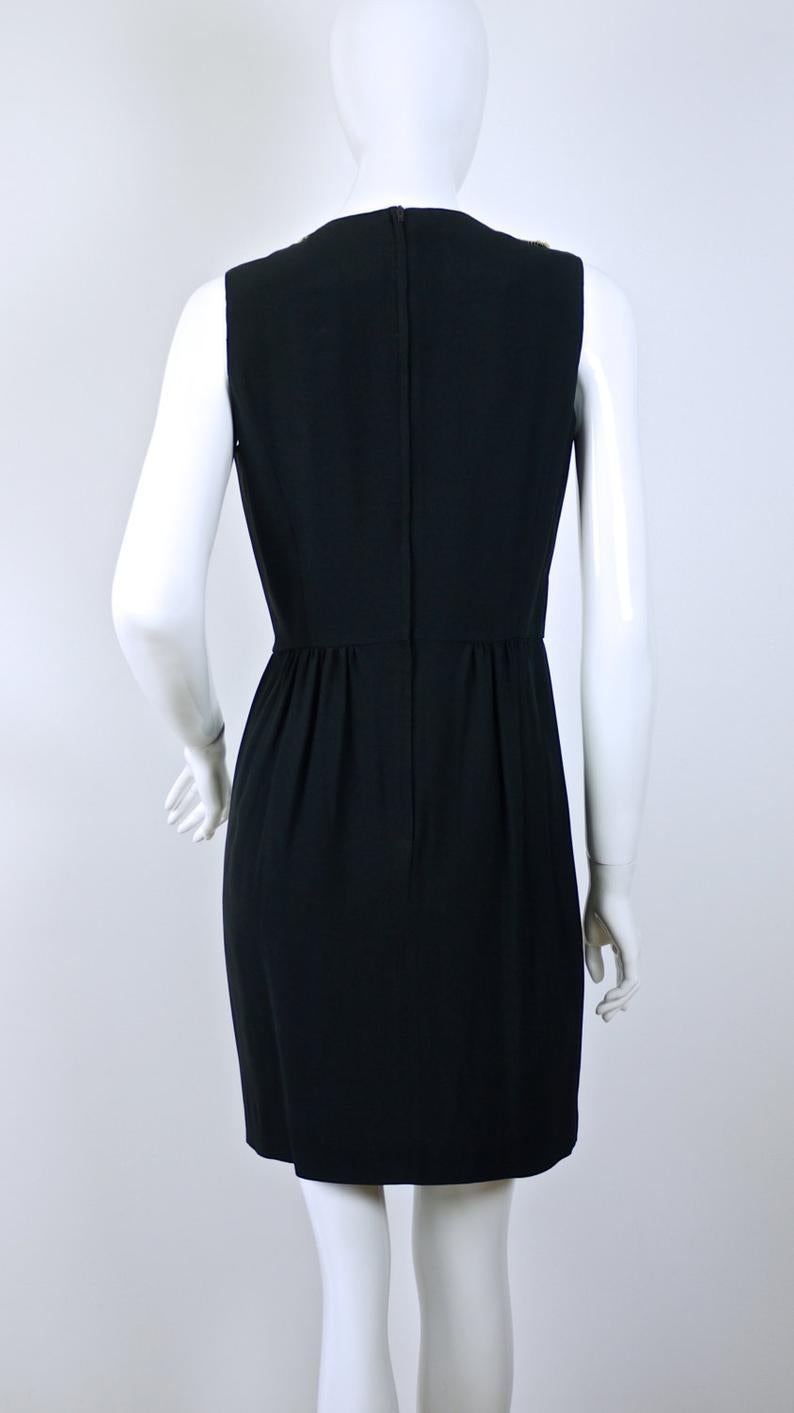 Vintage RARE COUTURE VIP Black Dress

Measurements taken laid flat, please double bust, waist and hips:
Shoulder: 13.5 inches
Bust: 18 inches
Waist: 14.5 inches
Hips: 19.5 inches
Length: 35.5 inches 

This Vintage MOSCHINO VIP Black Dress is witty
