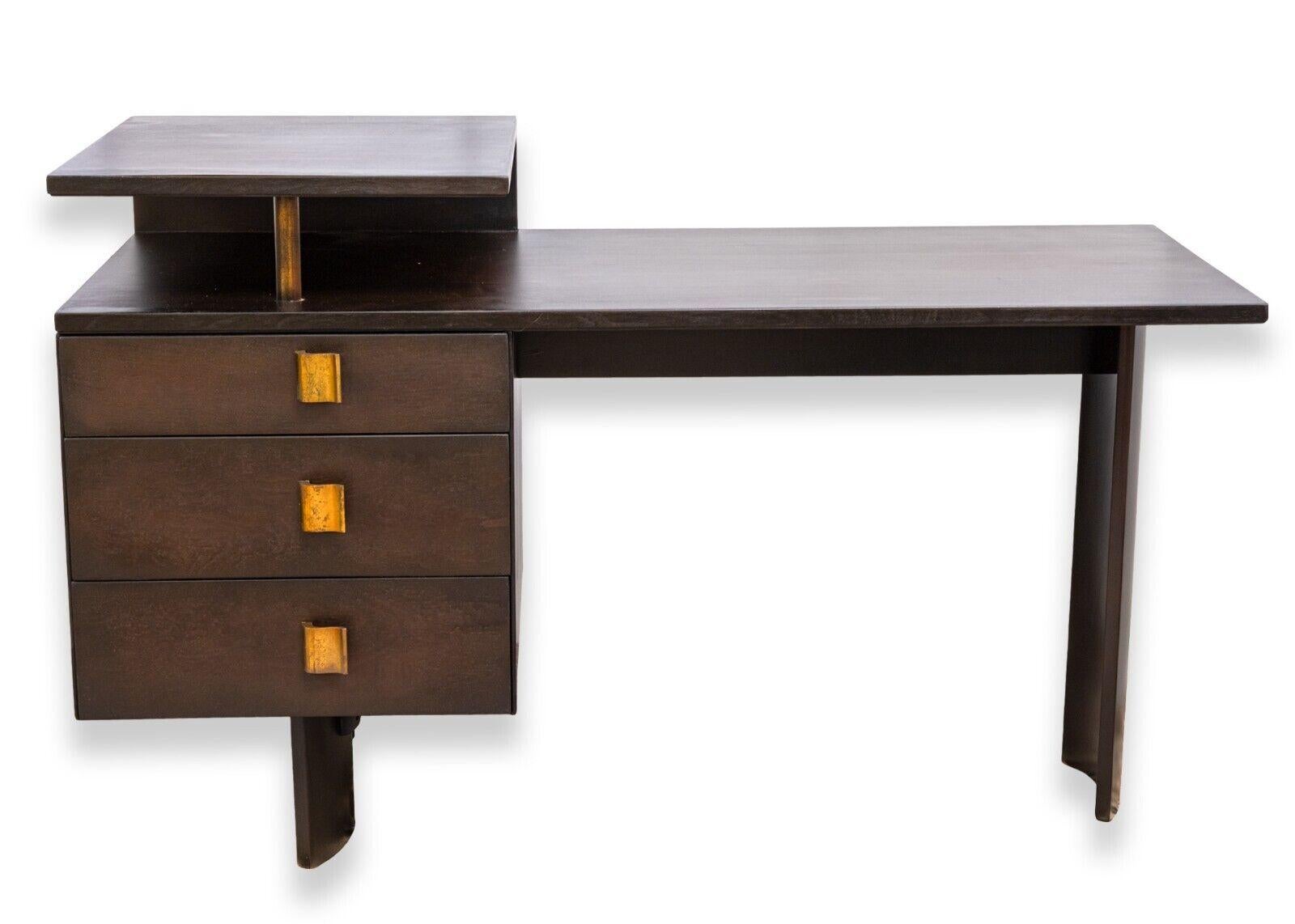 A vintage Eliel Saarinen for Johnson typing desk. This is a beautiful, rare vintage desk from an amazing designer. This desk, circa 1948, features a wonderful mid century design featuring S-shaped handles and legs, and a raised side desk top. This