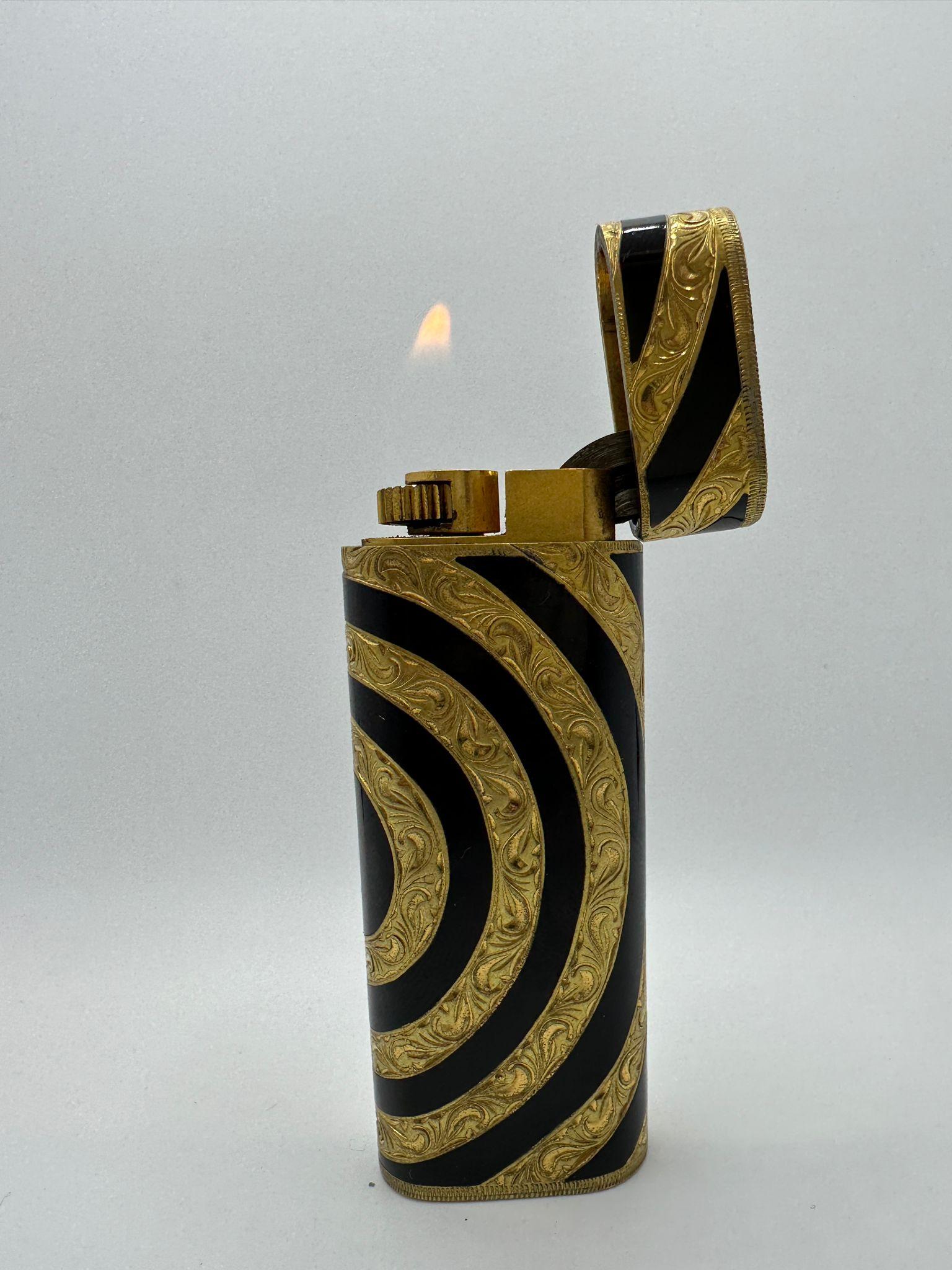 Vintage Exclusive Cartier Roy King Rollagas Lighter
Rare and Retro. 
Black enamel and Gold. 
Vintage. 
Ignites, sparks and flames. 
In mint working condition. 
Does not come with a box. 
It is gift rapped.
