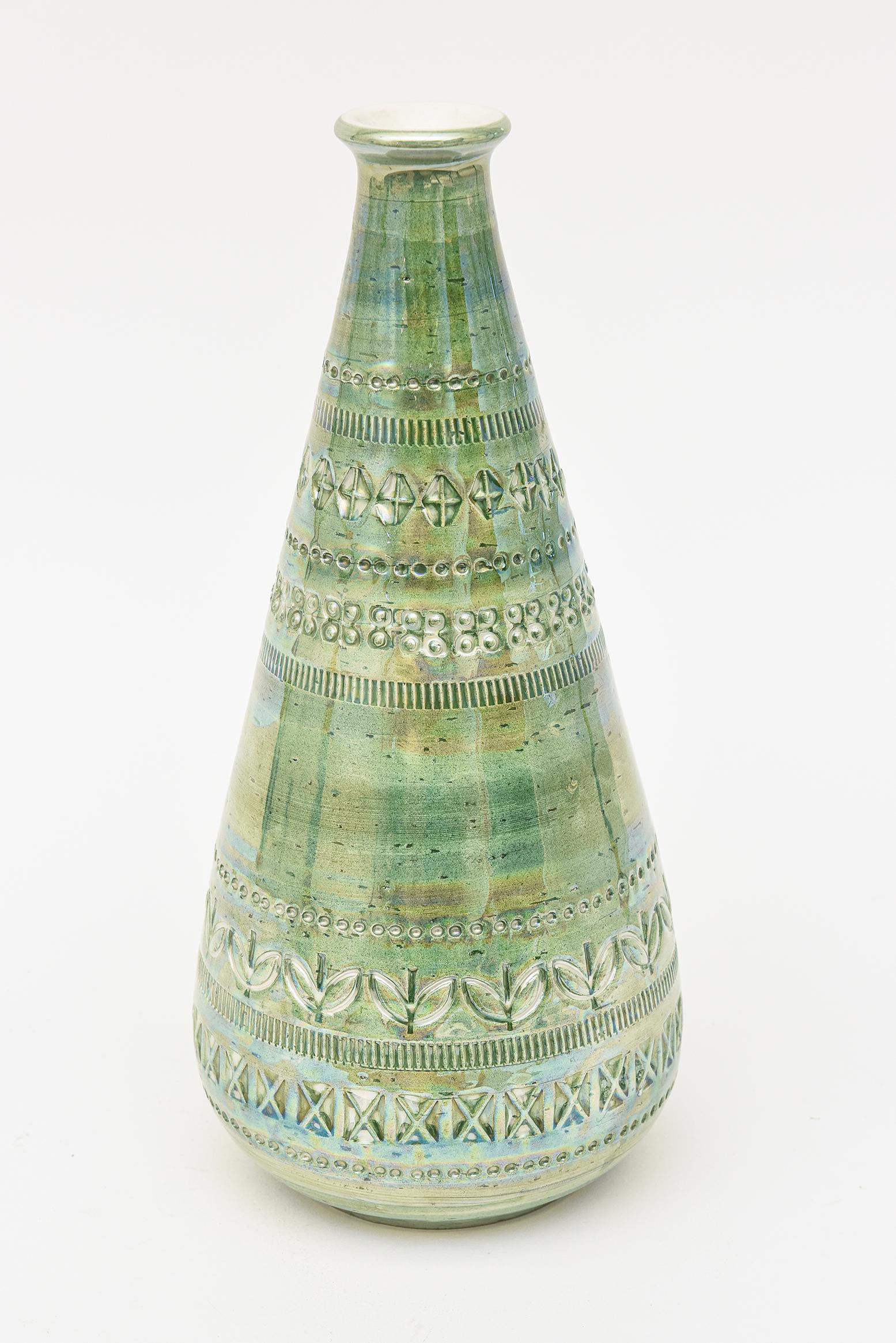 This stunning and rare Italian vintage hallmarked Bitossi glazed ceramic vessel is iridescent and resembling luster ware. This is from the 60's. It has incised designs and the colors are light green, pink, oranges, purples and greens. This is oh so