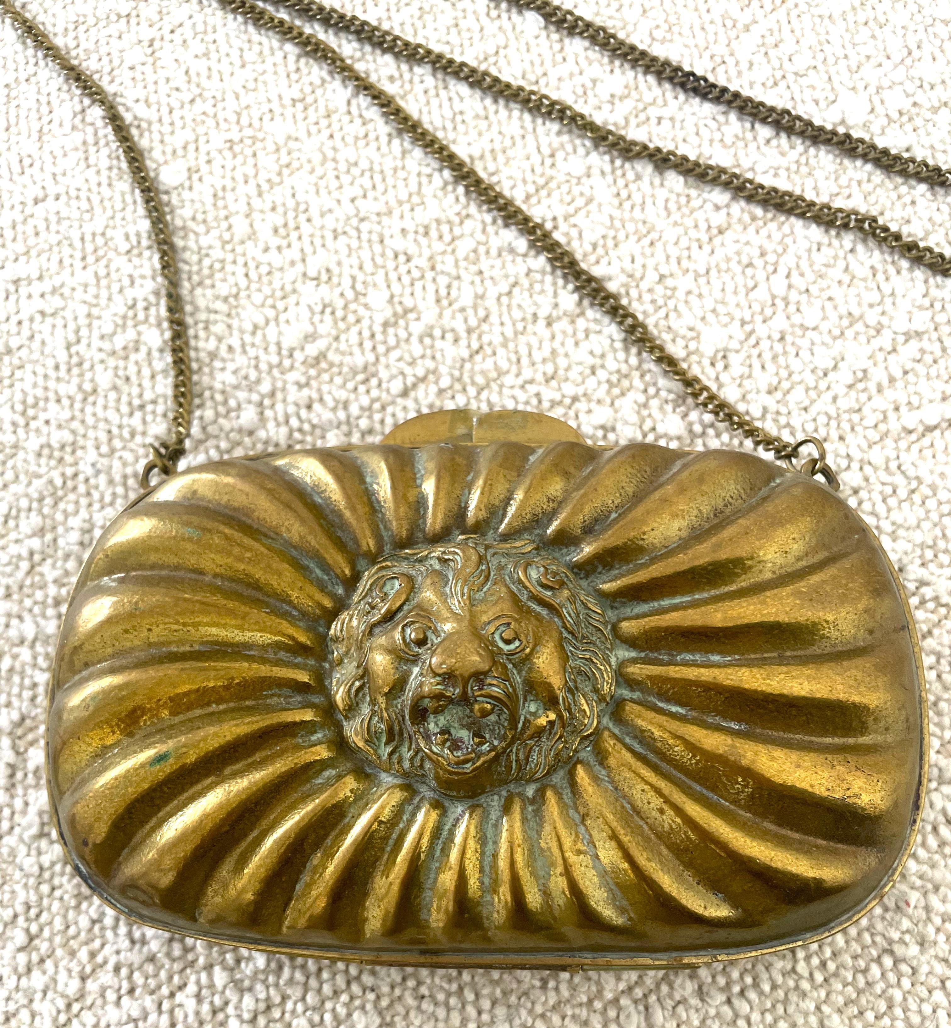 Steel the show with this authentic vintage rare Lion Head purse/evening bag in beautiful condition. 
Wear it and show this exceptional piece or hang or place in your home as a beautiful piece.  An antique copper purse bag with a lion’s head detail