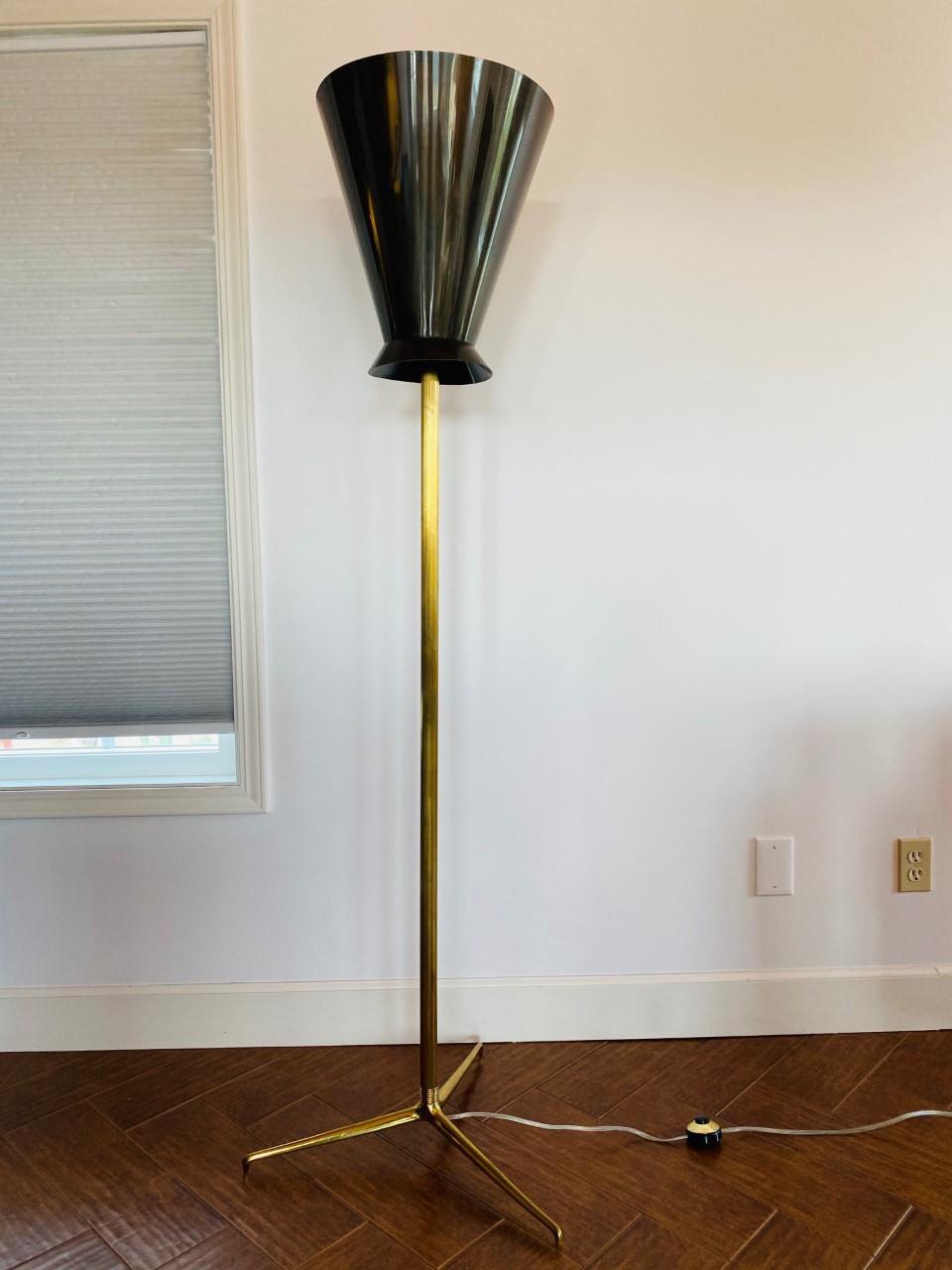 Floor lamp in the style of Karl Springer for Stiffel. This pieces exudes mid century glamour and style. The chic simple lines have impact and weight. The conical metal laminated shade is sculptural and adds weightless drama as it stems on a patina